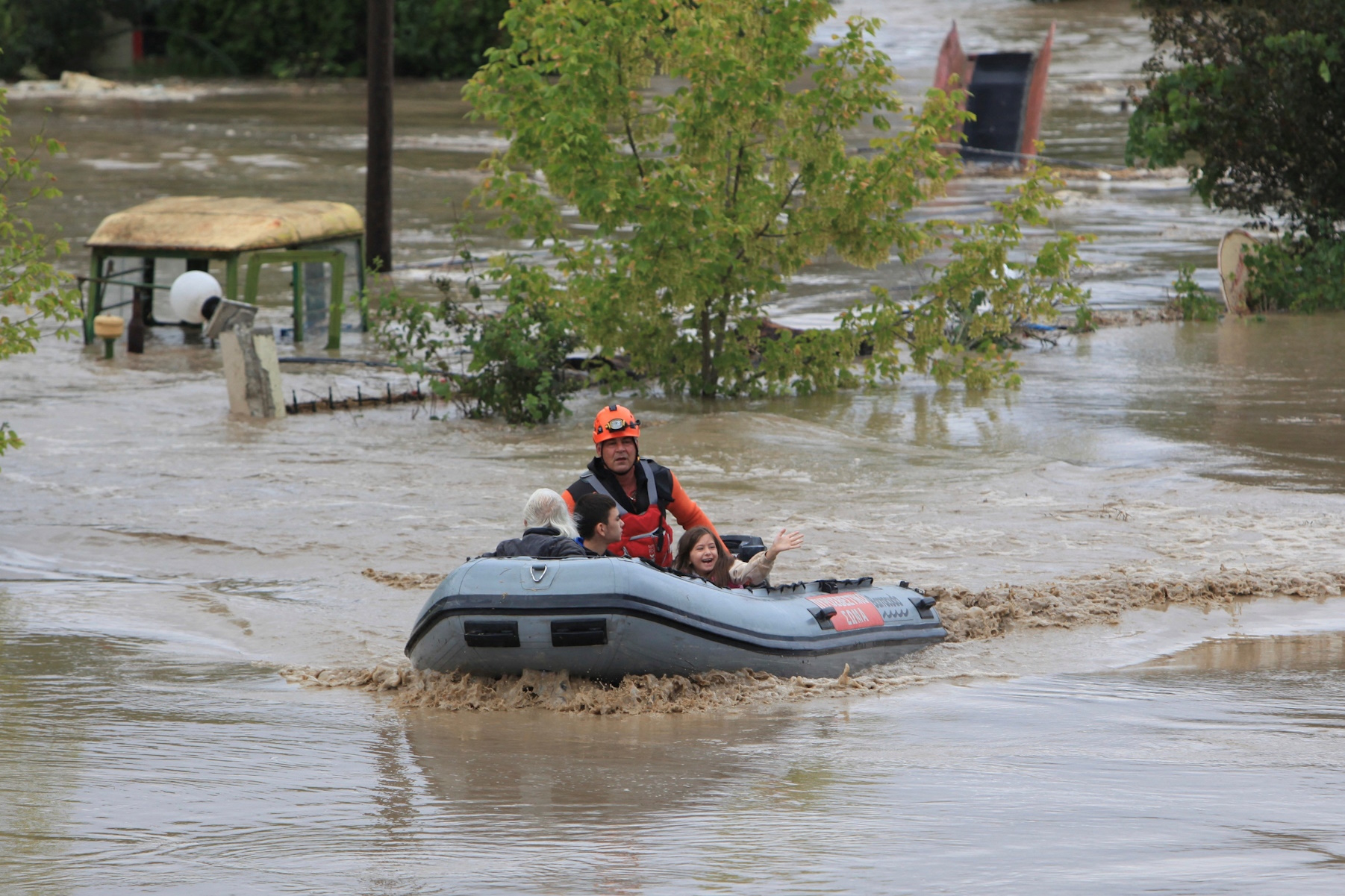 Young Georgia waves as she is rescued by firefighters from an area flooded due to the impact of storm "Daniel" in the city of Larissa, Greece, September 6, 2023. REUTERS