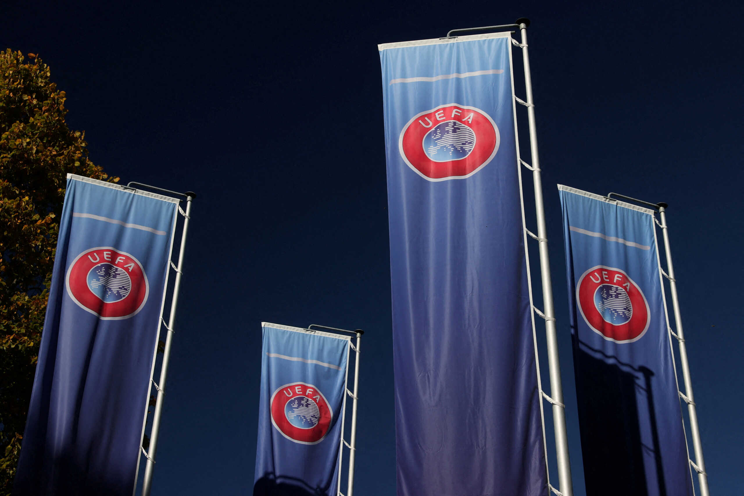 FILE PHOTO: Flags with UEFA logo are seen outside of the Union of European Football Associations headquarters in Nyon, Switzerland, October 5, 2022. REUTERS