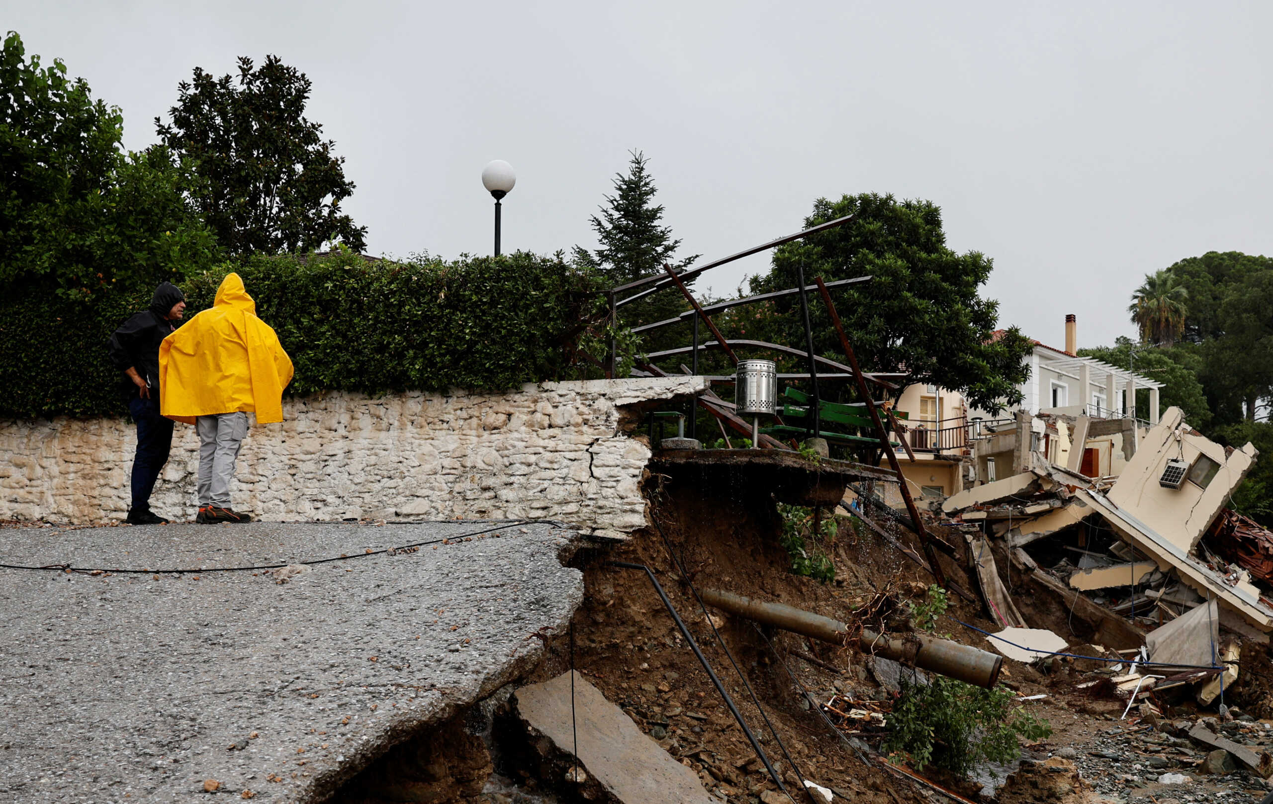 People look on next to damage due to the impact of storm Daniel, near a nursing home in the city of Volos, Greece, September 6, 2023. REUTERS