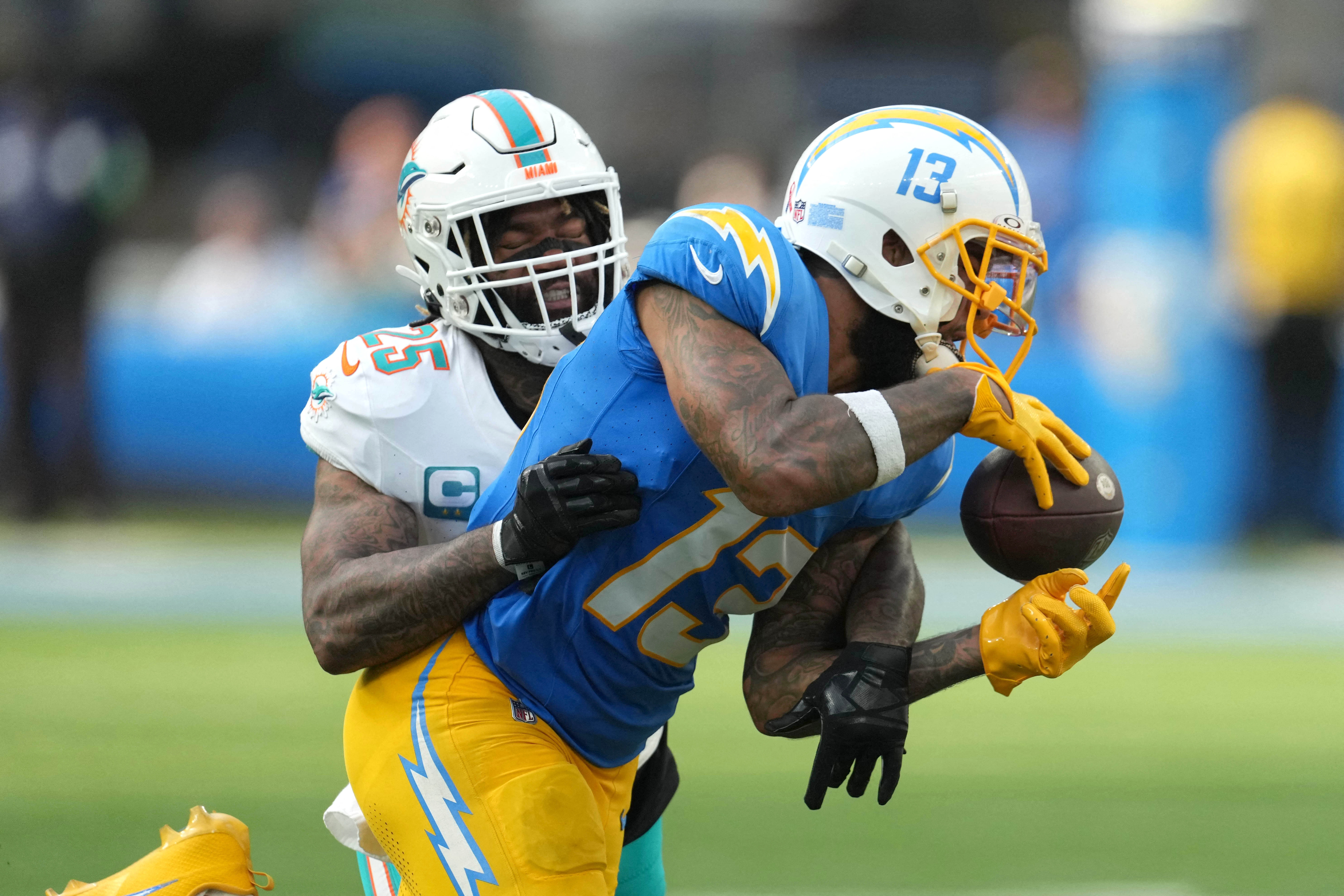 Sep 10, 2023; Inglewood, California, USA; Los Angeles Chargers wide receiver Keenan Allen (13) attempts to catch the ball against Miami Dolphins cornerback Xavien Howard (25) in the second half at SoFi Stadium. Mandatory Credit: Kirby Lee-USA TODAY Sports