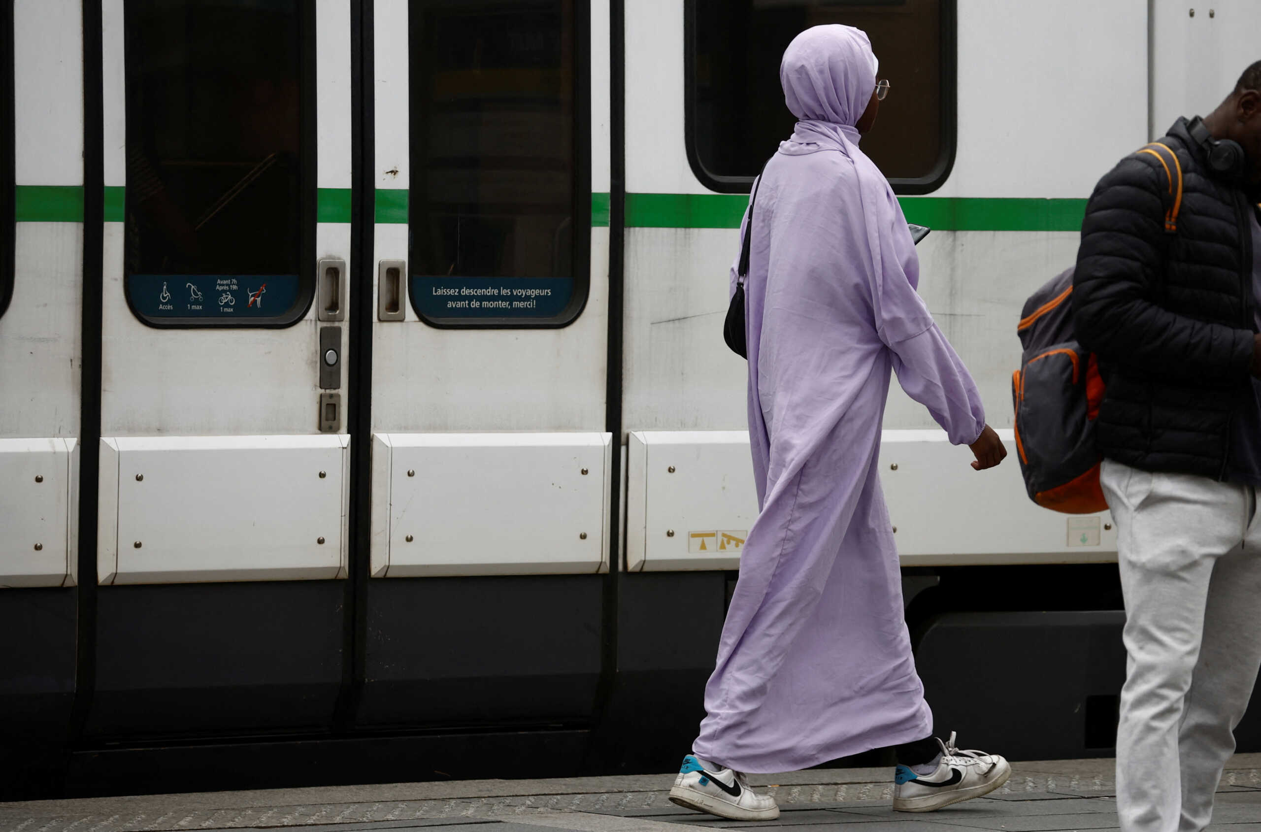 A Muslim woman, wearing the style of dress called an abaya, walks in a street in Nantes, France, August 29, 2023. REUTERS