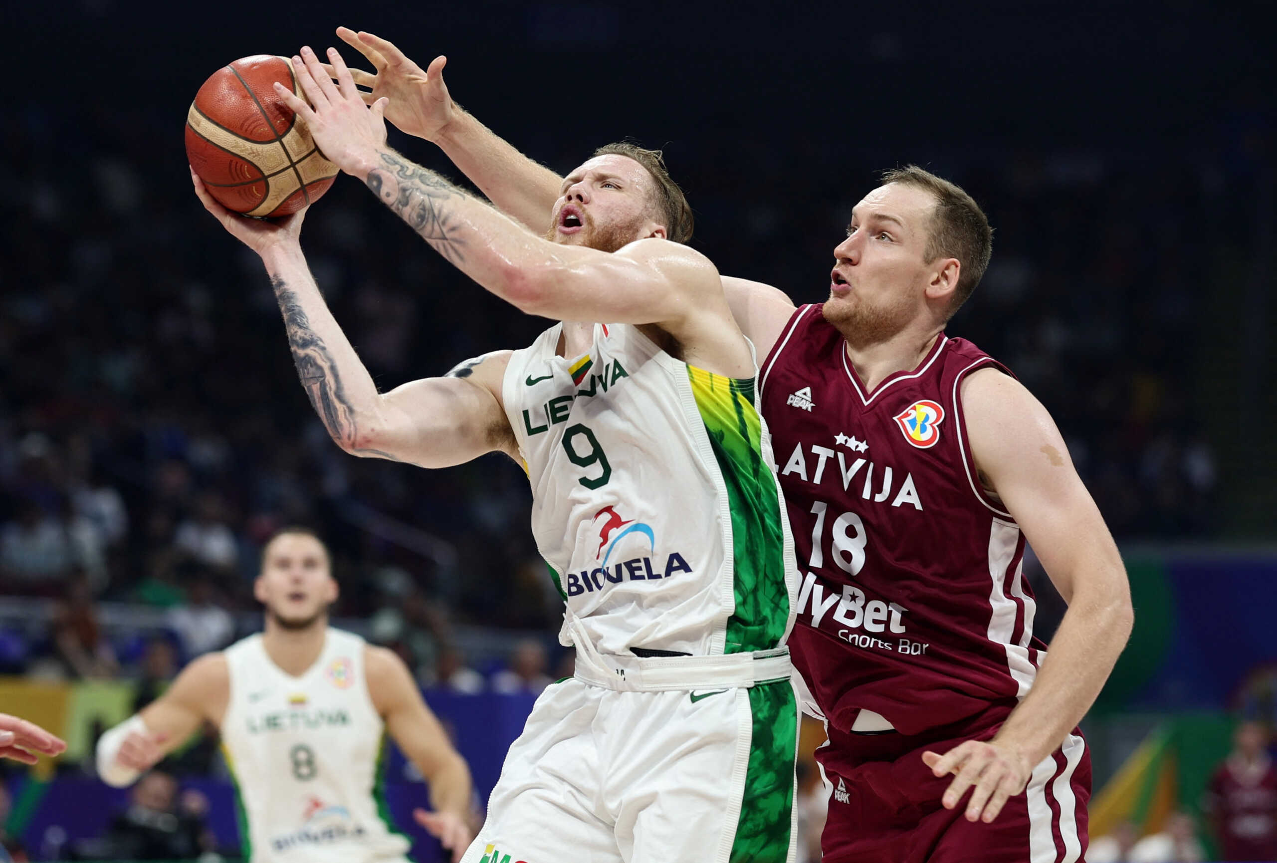 Basketball - FIBA World Cup 2023 - Classification Games 5-6 - Latvia v Lithuania - Mall of Asia Arena, Manila, Philippines - September 9, 2023 Lithuania's Ignas Brazdeikis in action with Latvia's Klavs Cavars REUTERS