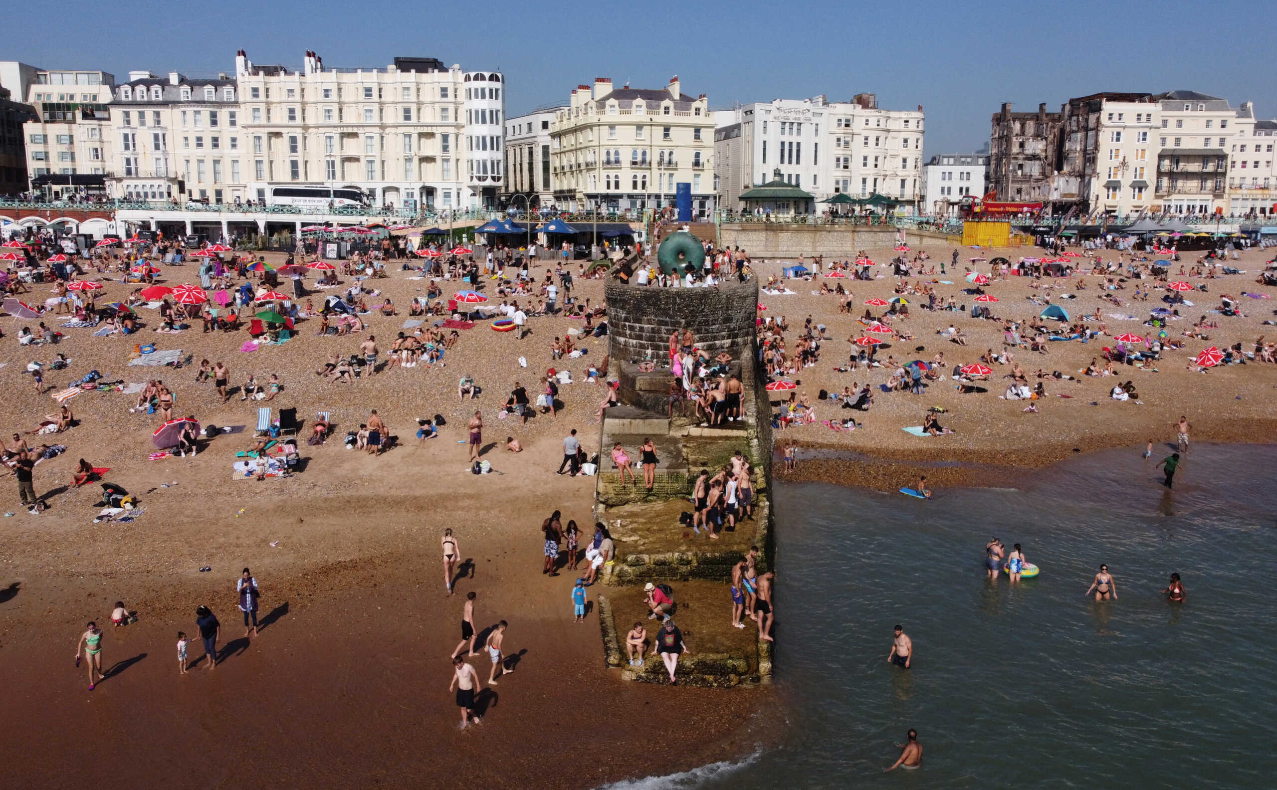 Beach-goers cool off in water to escape the heat in Brighton, Britain, September 9, 2023. REUTERS