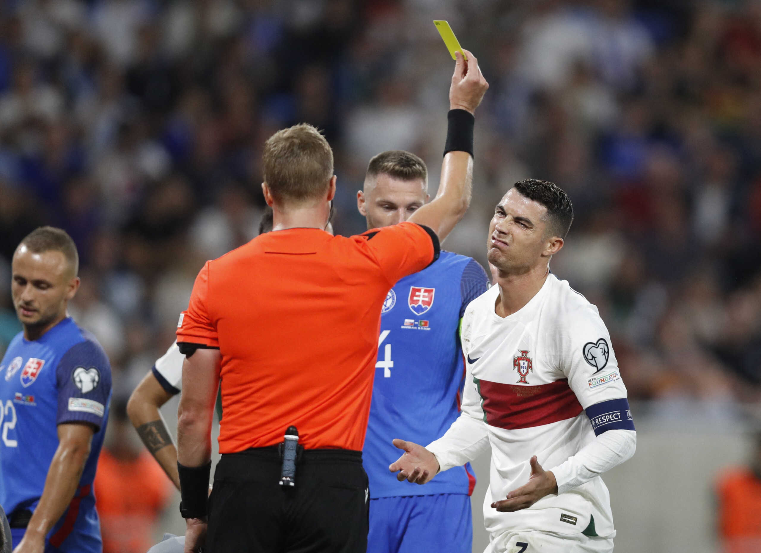 Soccer Football - Euro 2024 Qualifier - Group J - Slovakia v Portugal - Tehelne pole, Bratislava, Slovakia - September 8, 2023 Portugal's Cristiano Ronaldo is shown a yellow card by referee Glenn Nyberg REUTERS
