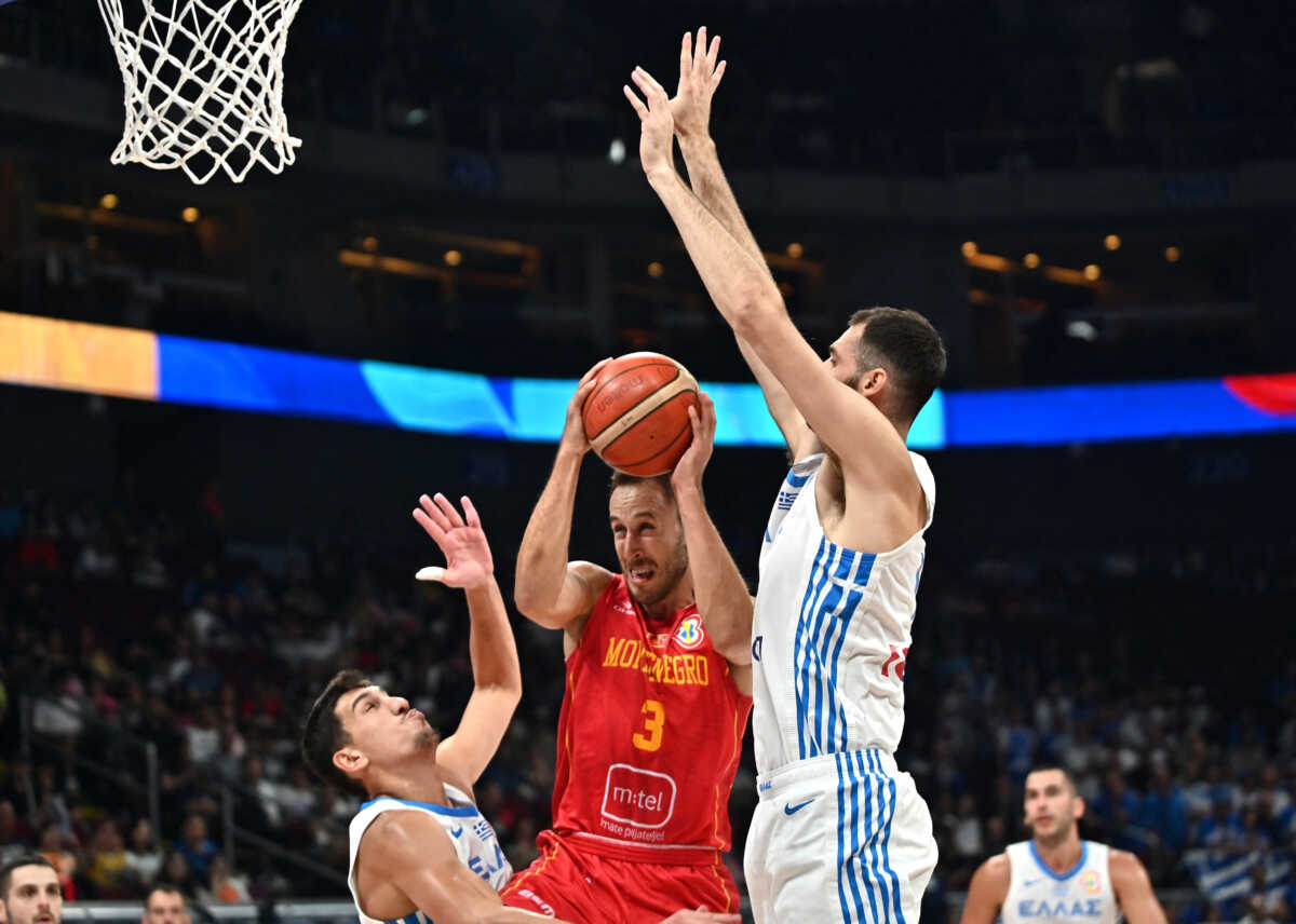 Basketball - FIBA World Cup 2023 - Second Round - Group J - Greece v Montenegro - Mall of Asia Arena, Manila, Philippines - September 3, 2023 Montenegro's Vladimir Mihailovic in action with Greece's Georgios Papagiannis REUTERS