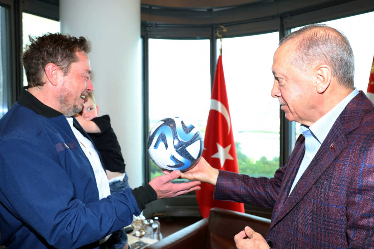 Turkey's President Tayyip Erdogan presents a ball as he meets with Tesla CEO Elon Musk in New York, U.S., September 17, 2023. Murat Cetinmuhurdar