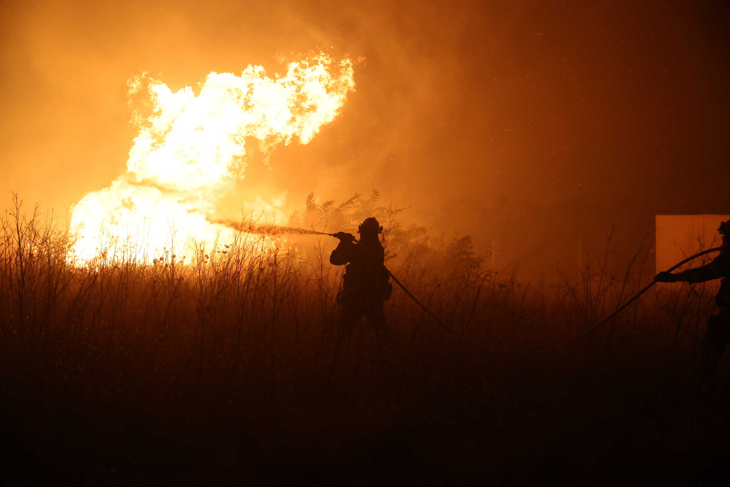 A firefighter tries to extinguish a wildfire burning near the village of Makri on the region of Evros, Greece, August 22, 2023. REUTERS