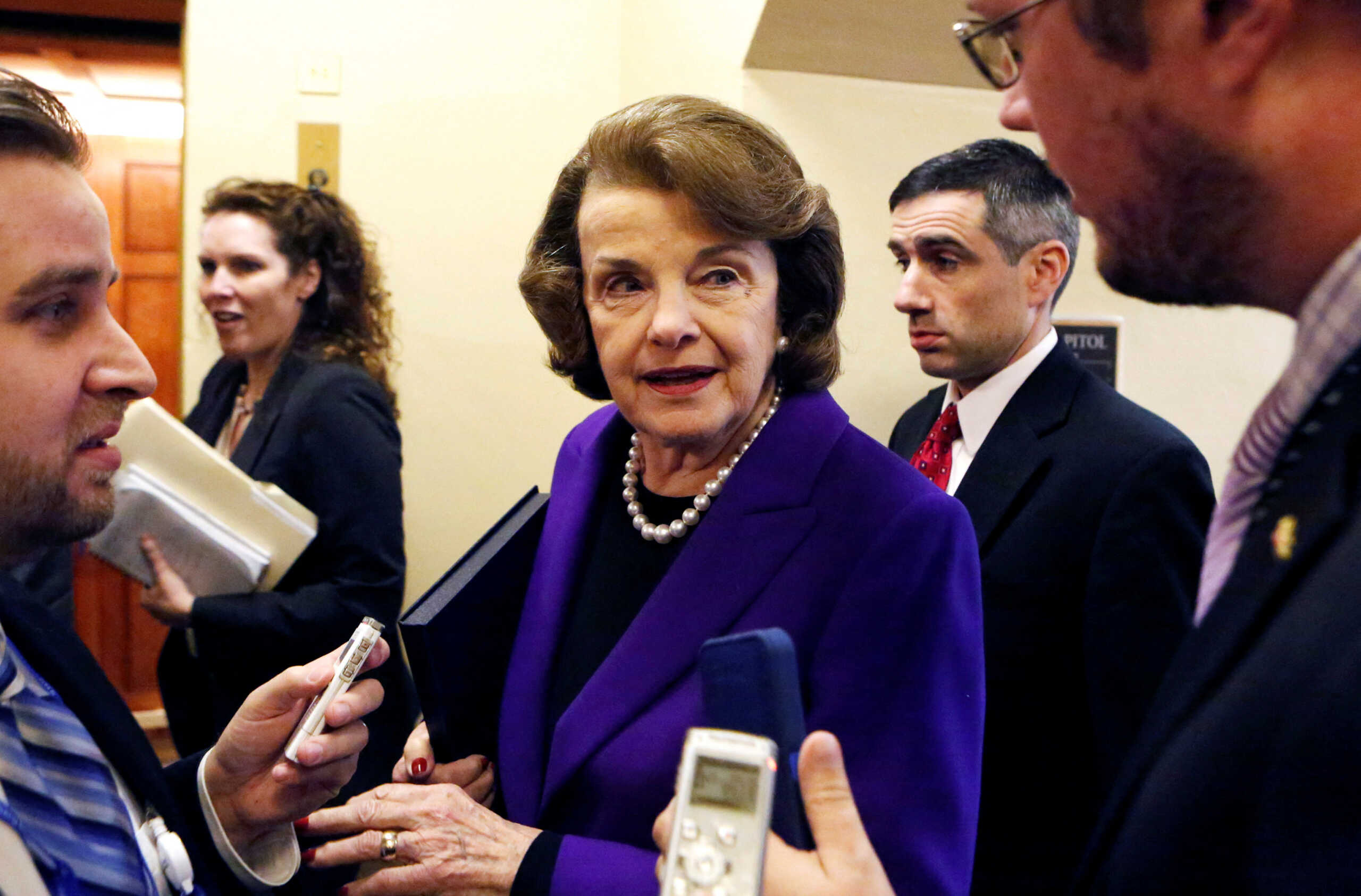 FILE PHOTO: U.S. Senator Dianne Feinstein (D-CA) (C) talks to reporters as she walks to the Senate floor on Capitol Hill, in Washington December 9, 2014. The CIA used sexual threats, waterboarding and other harsh methods to interrogate terrorism suspects and all were ineffective at eliciting critical information, according to a U.S. Senate report due to be released on Tuesday. REUTERS