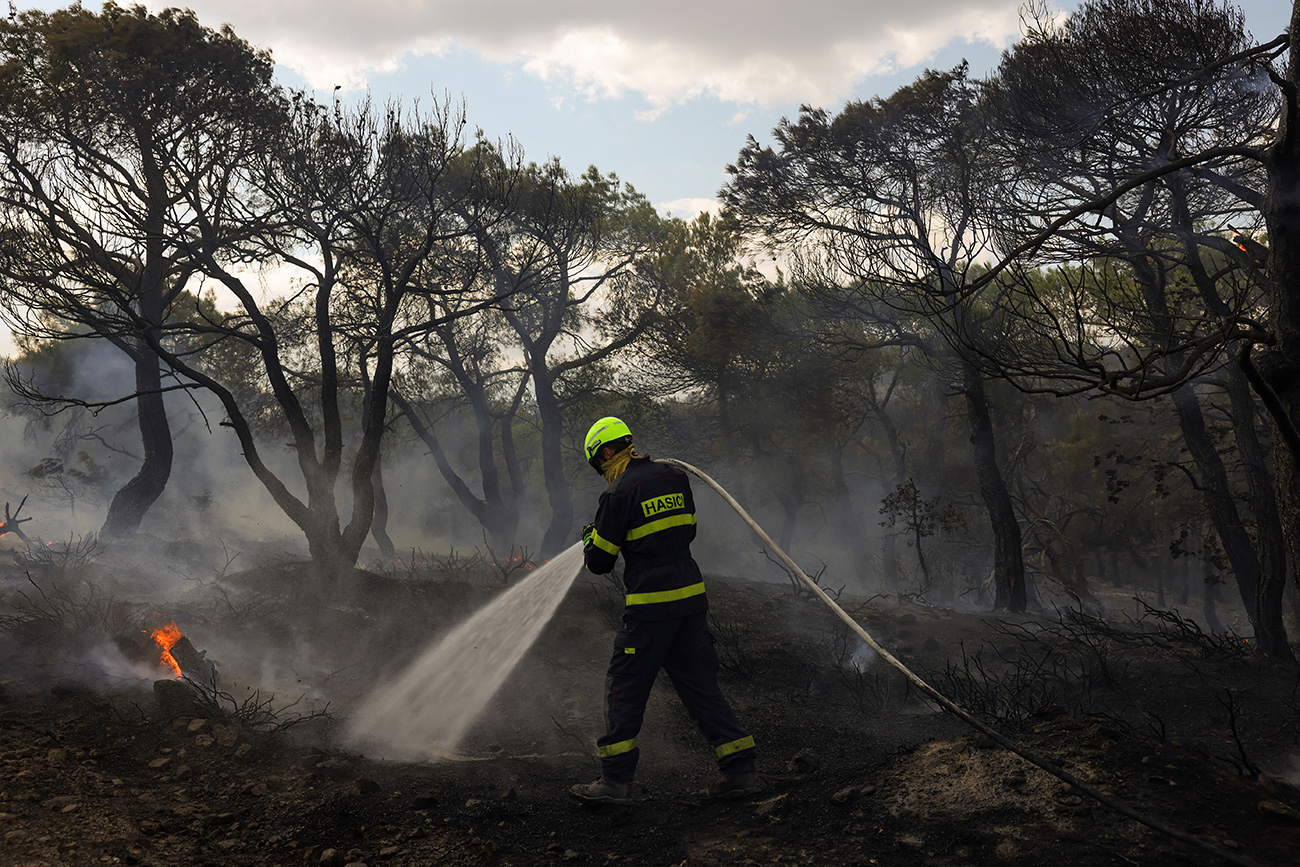 A Czech firefighter tries to extinguish a wildfire burning near the village of Provatonas in the region of Evros, Greece, September 3, 2023. REUTERS