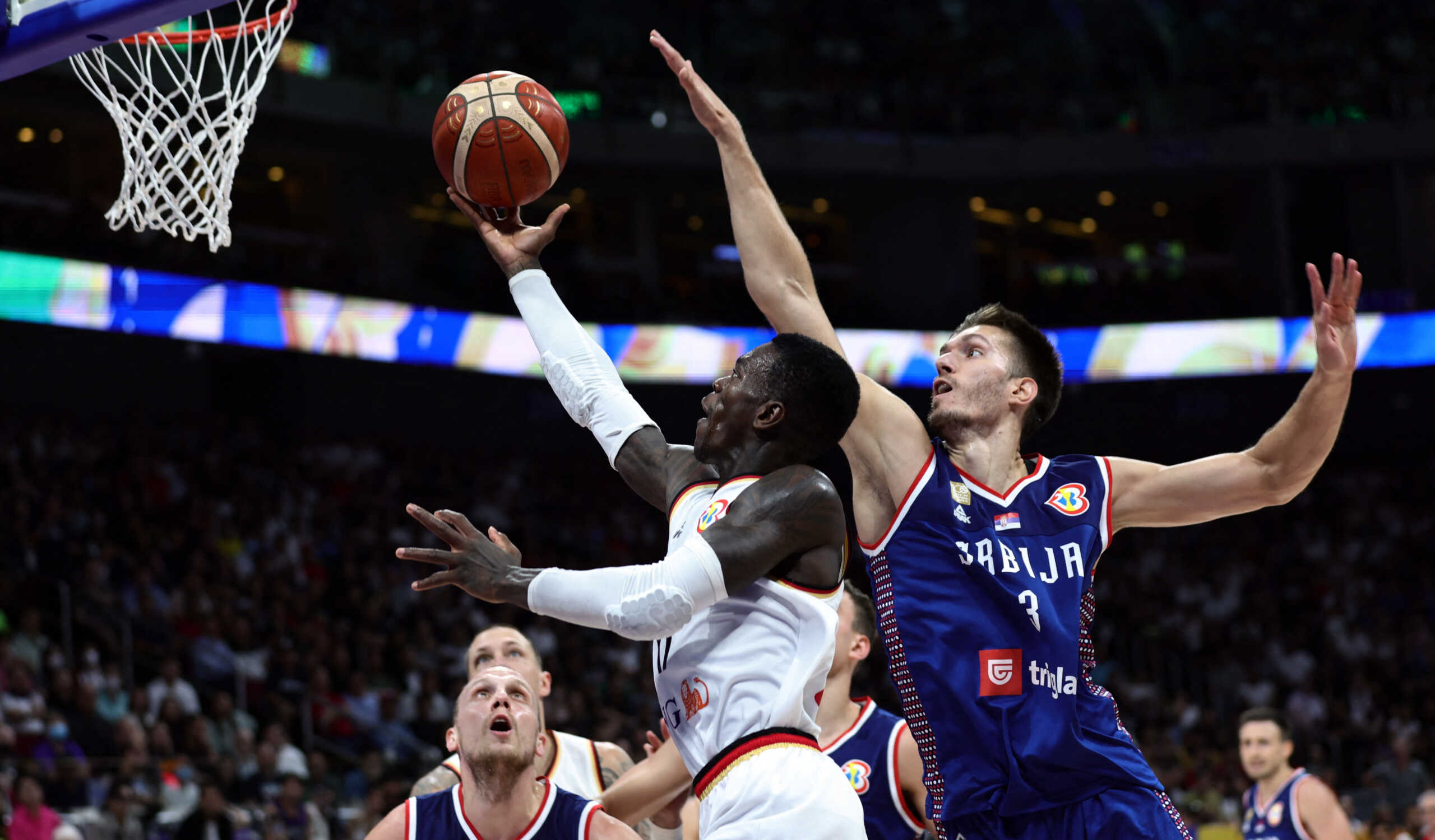 Basketball - FIBA World Cup 2023 - Final - Germany v Serbia - Mall of Asia Arena, Manila, Philippines - September 10, 2023 Germany's Dennis Schroder in action with Serbia's Filip Petrusev REUTERS