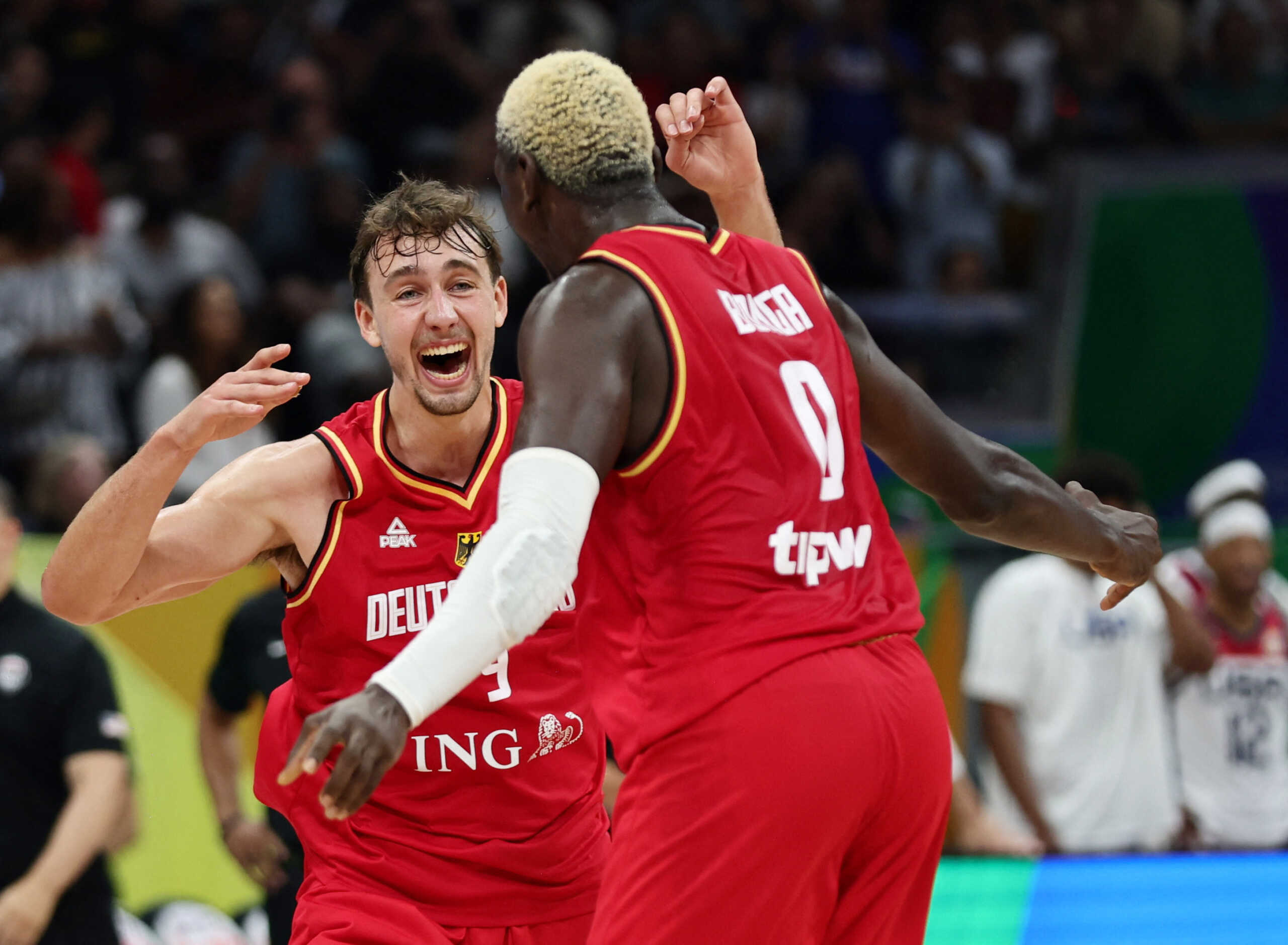 Basketball - FIBA World Cup 2023 - Semi Final - United States v Germany - Mall of Asia Arena, Manila, Philippines - September 8, 2023 Germany's Franz Wagner and Isaac Bonga celebrate after the match REUTERS