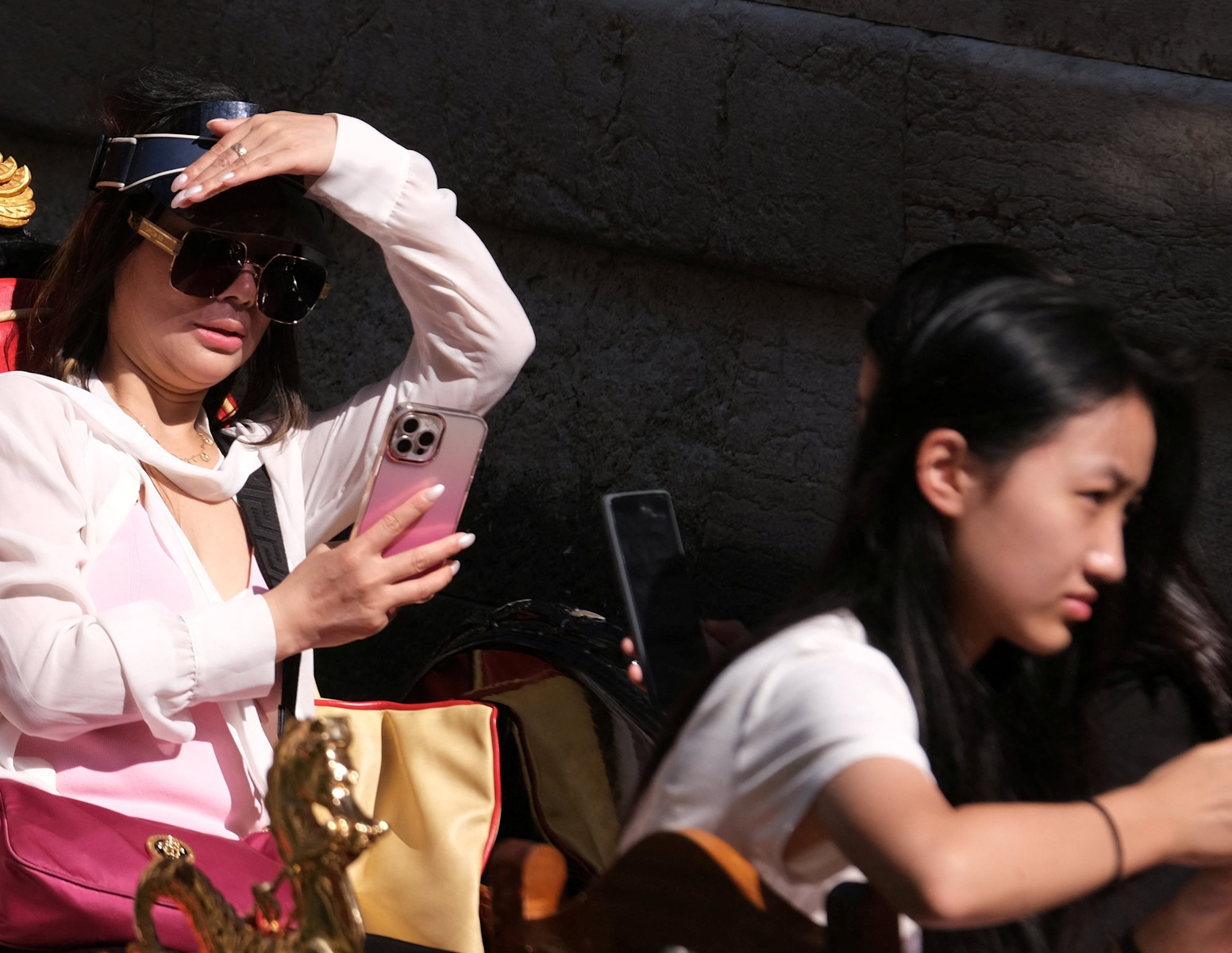 Tourists sit in gondola during a new heat wave as temperatures are expected to reach 40 degrees in some cities, in Venice, Italy August 22, 2023. REUTERS