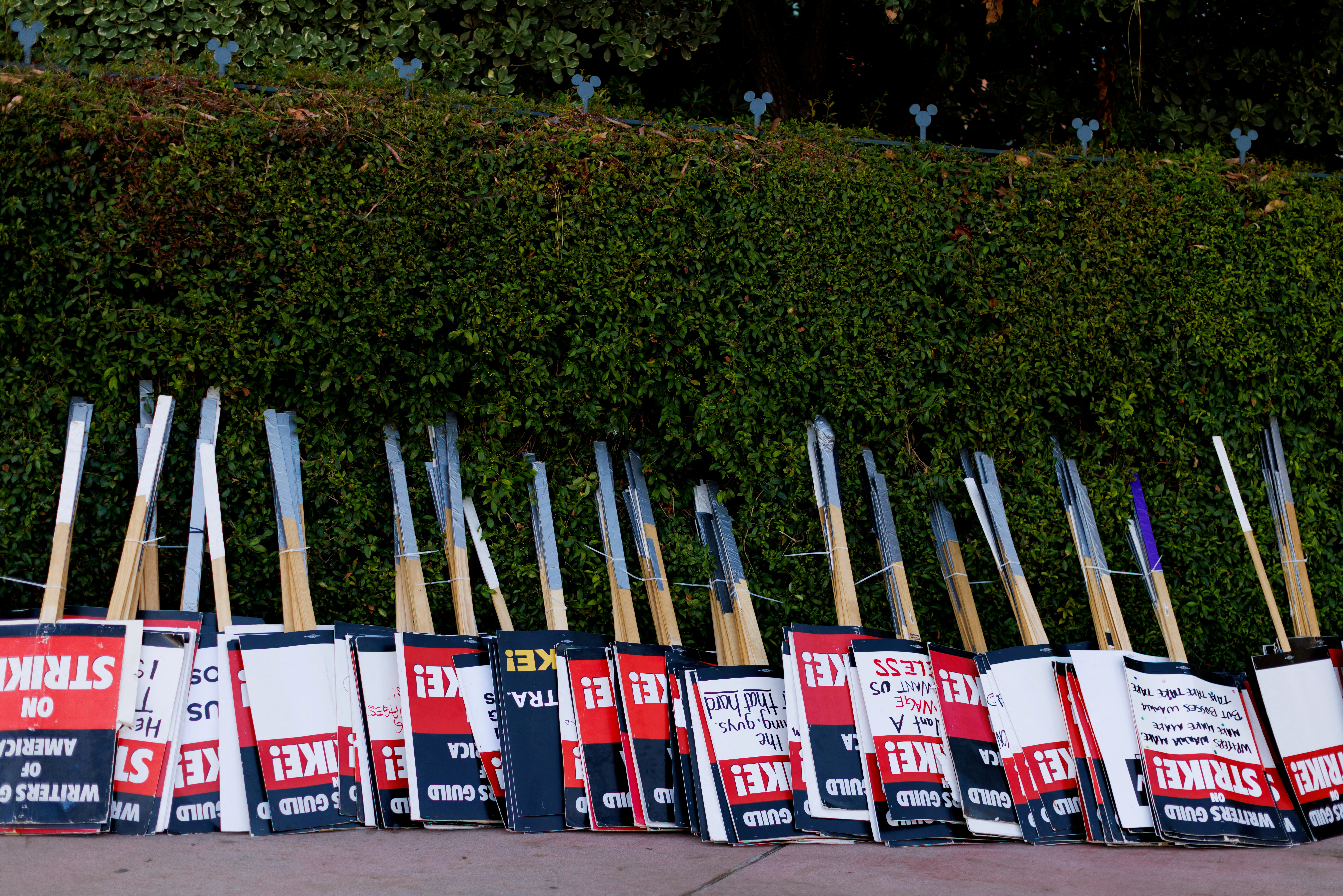 FILE PHOTO: Strike signs await striking SAG-AFTRA actors and Writers Guild of America (WGA) outside Disney Studios in Burbank, California, U.S., July 25, 2023. REUTERS