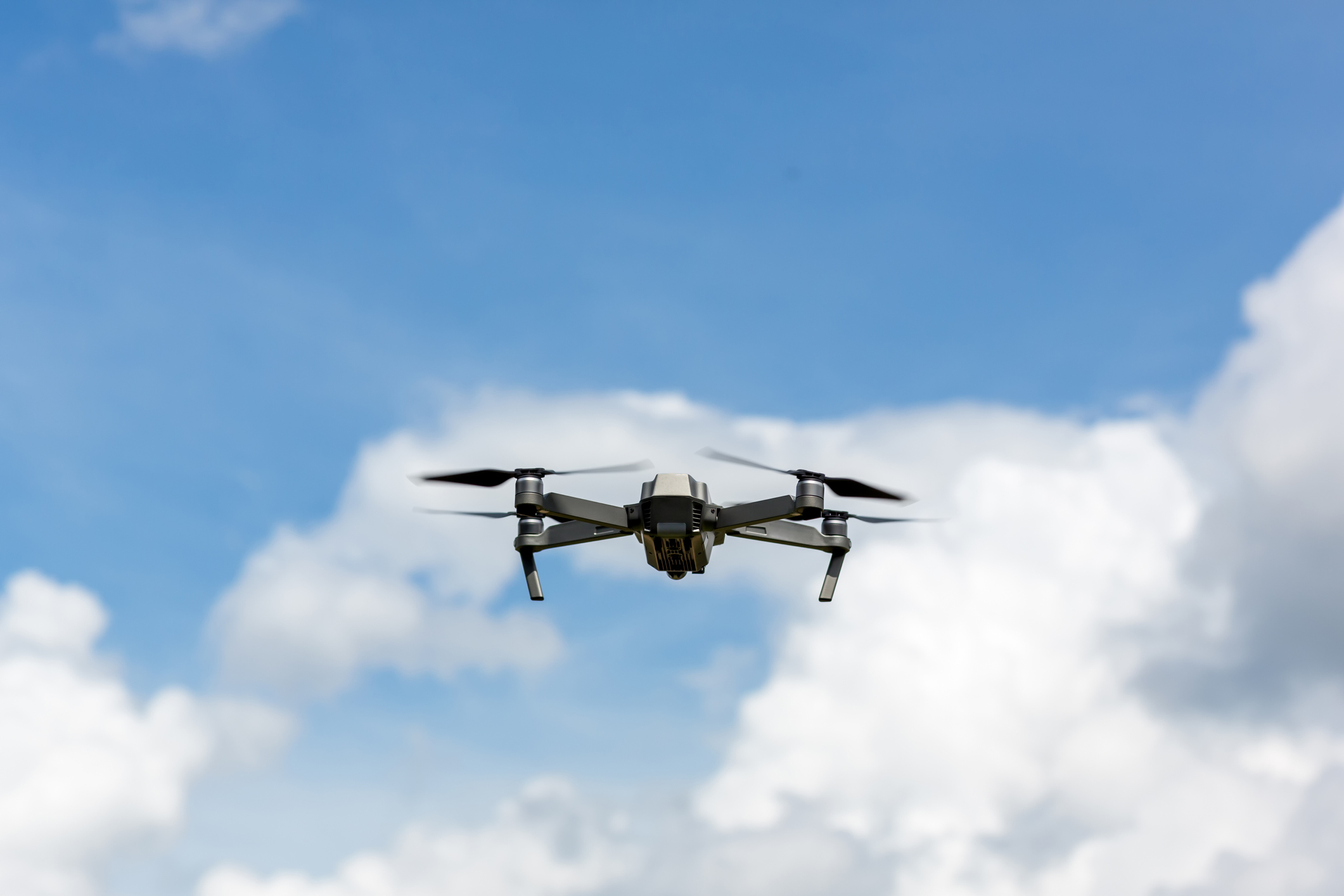 Drone copter flying with digital camera.Drone with high resolution digital camera. Flying camera take a photo and video.The drone with professional camera takes pictures of the misty mountains.