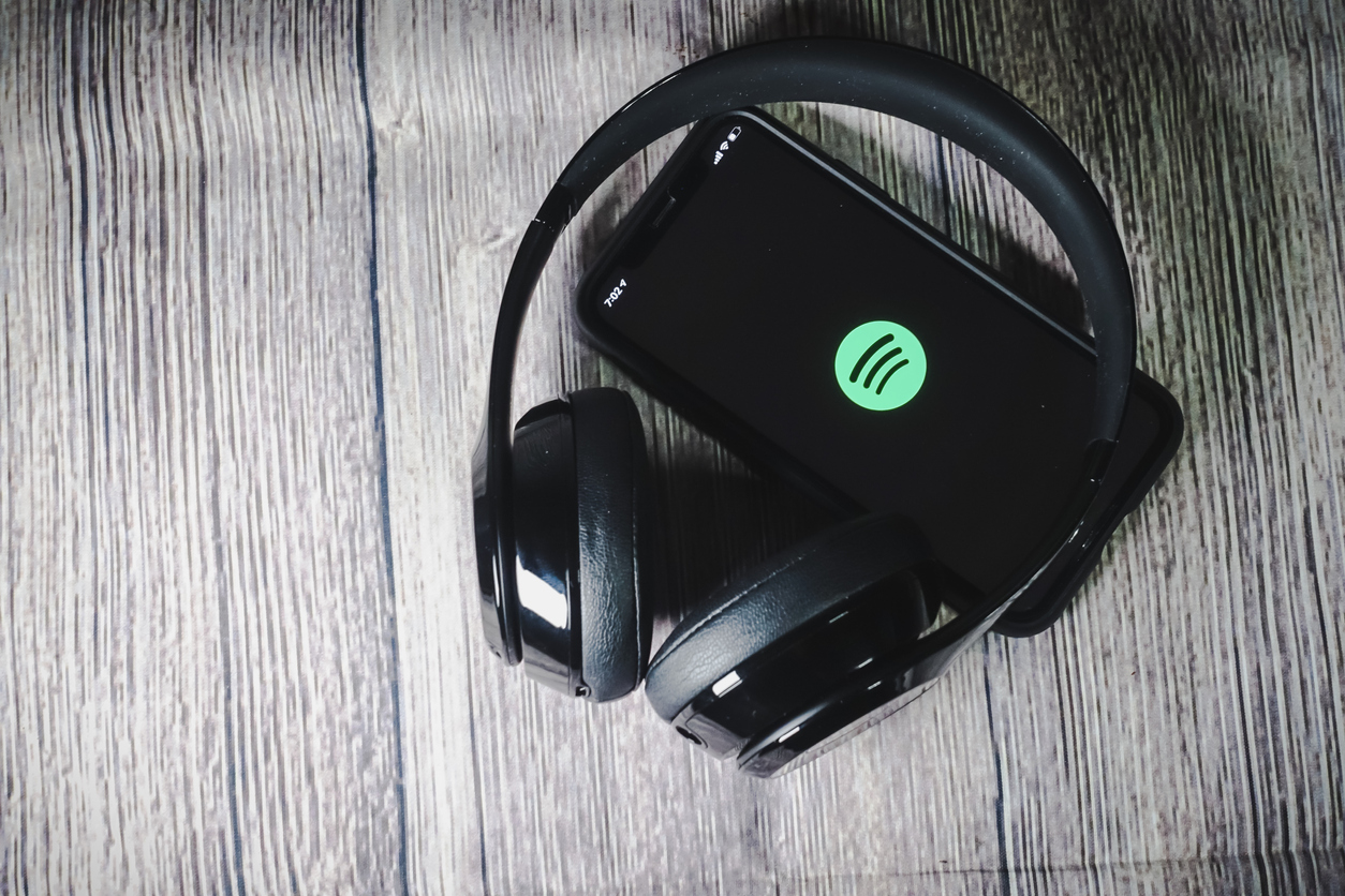 An iphone 11 screen showing spotify icon with beats earphone, perfect for listening musics on the go