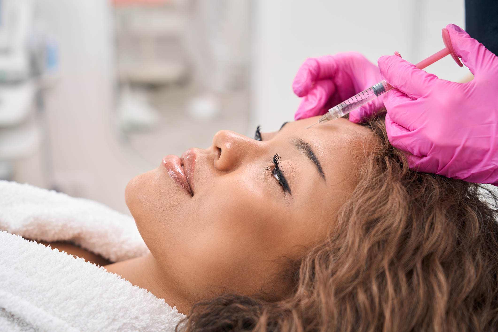 Modern woman receives botulinum toxin injections in a cosmetology clinic, patient is provided with maximum comfort and attention