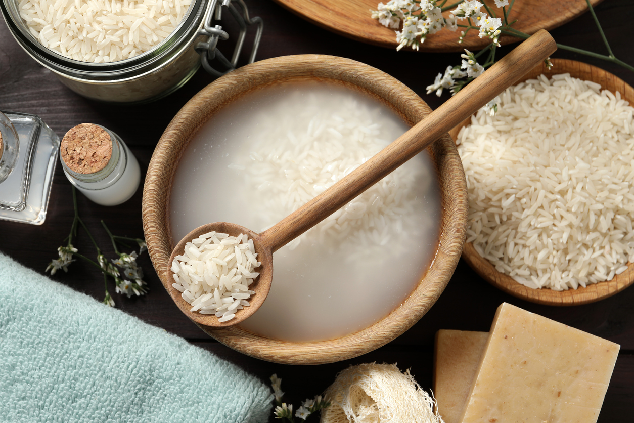 Flat lay composition with soaked rice on wooden table