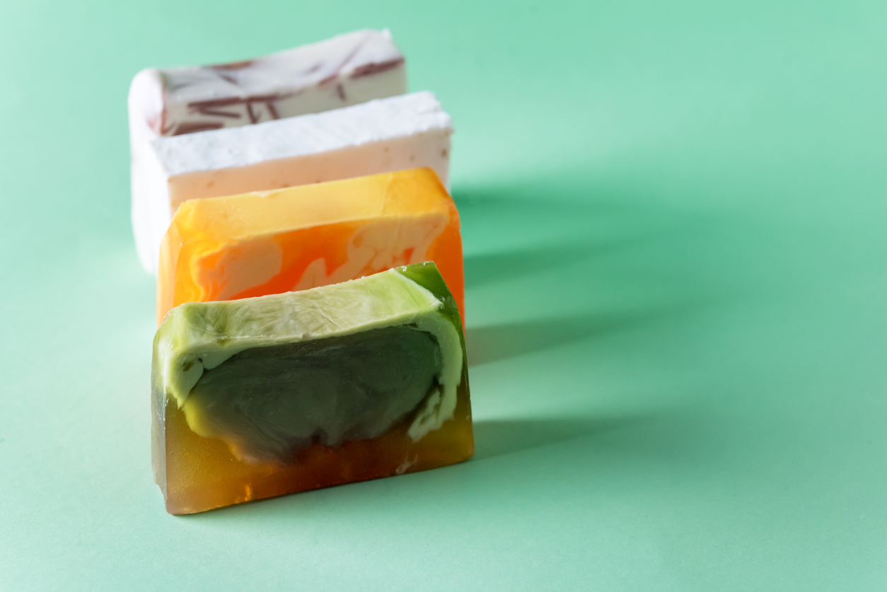 Set of Natural Handmade Soap on Green Background Copy Space Horizontal