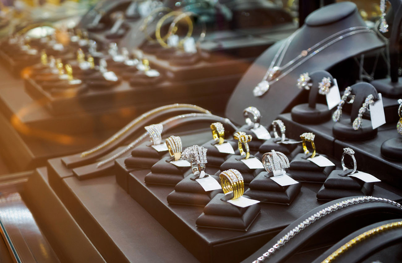 Gold jewelry diamond shop with rings and necklaces luxury retail store window display showcase