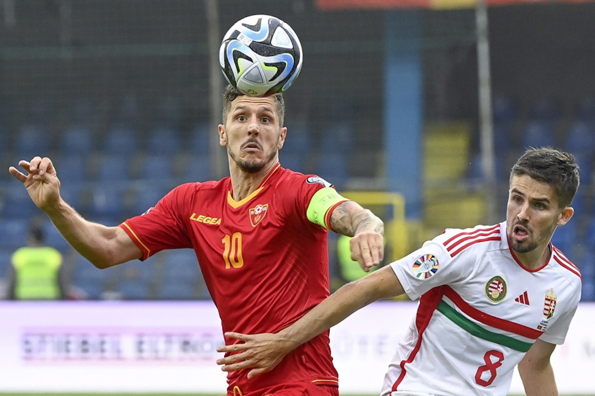 epa10697057 Adam Nagy (R) of Hungary in action against Stevan Jovetic of Montenegro during the UEFA EURO 2024 qualifier soccer match between Montenegro and Hungary, in Podgorica, Montenegro, 17 June 2023.  EPA