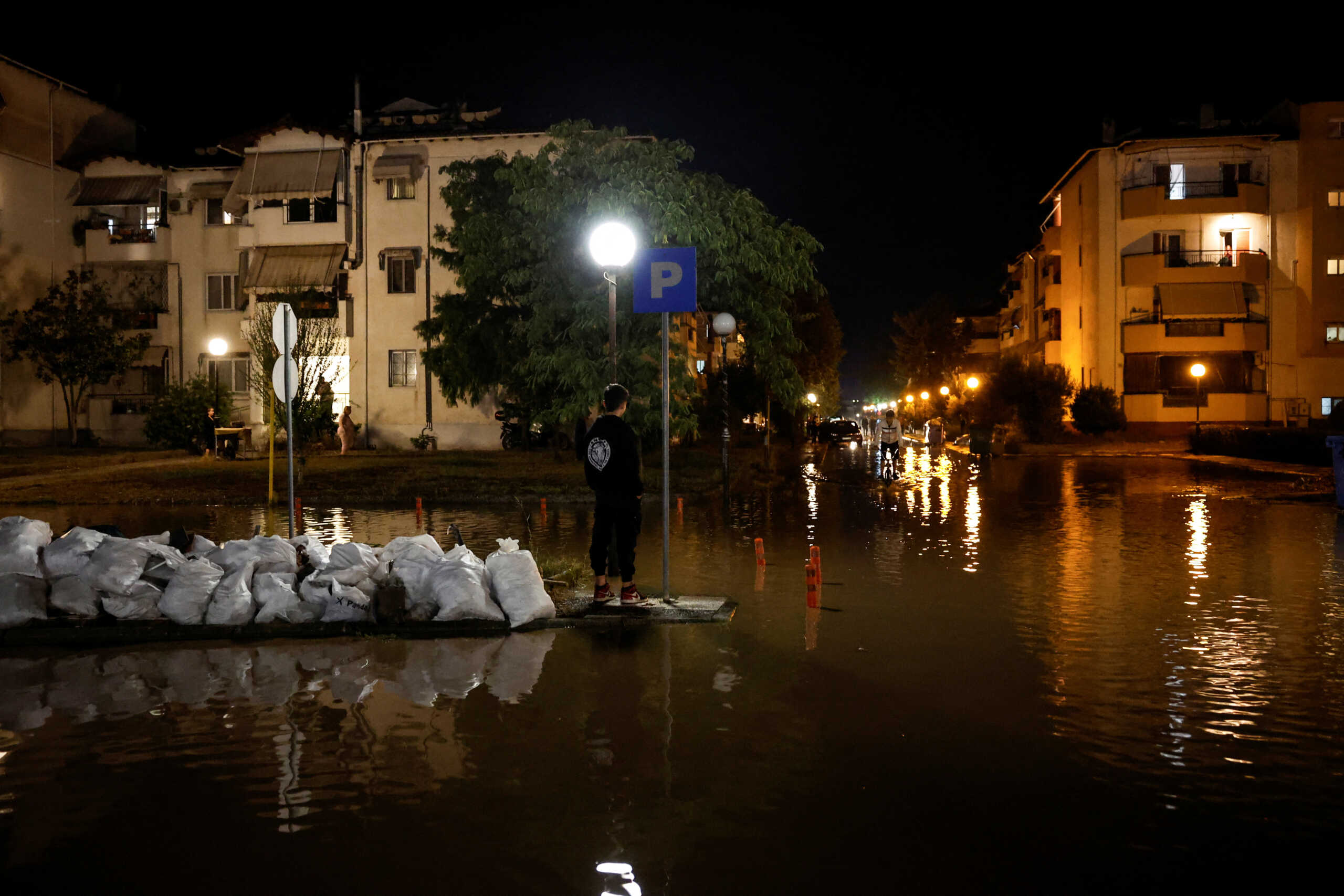 Residents look at floodwaters, as the Pinios river waters rise in Larissa, Greece, early September 8, 2023. REUTERS
