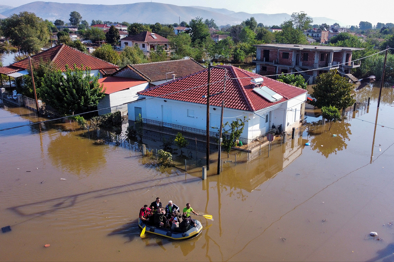 Locals get evacuated on a rubber boat as flood waters cover the town of Palamas, in the aftermath of Storm Daniel, Greece, September 8, 2023. REUTERS