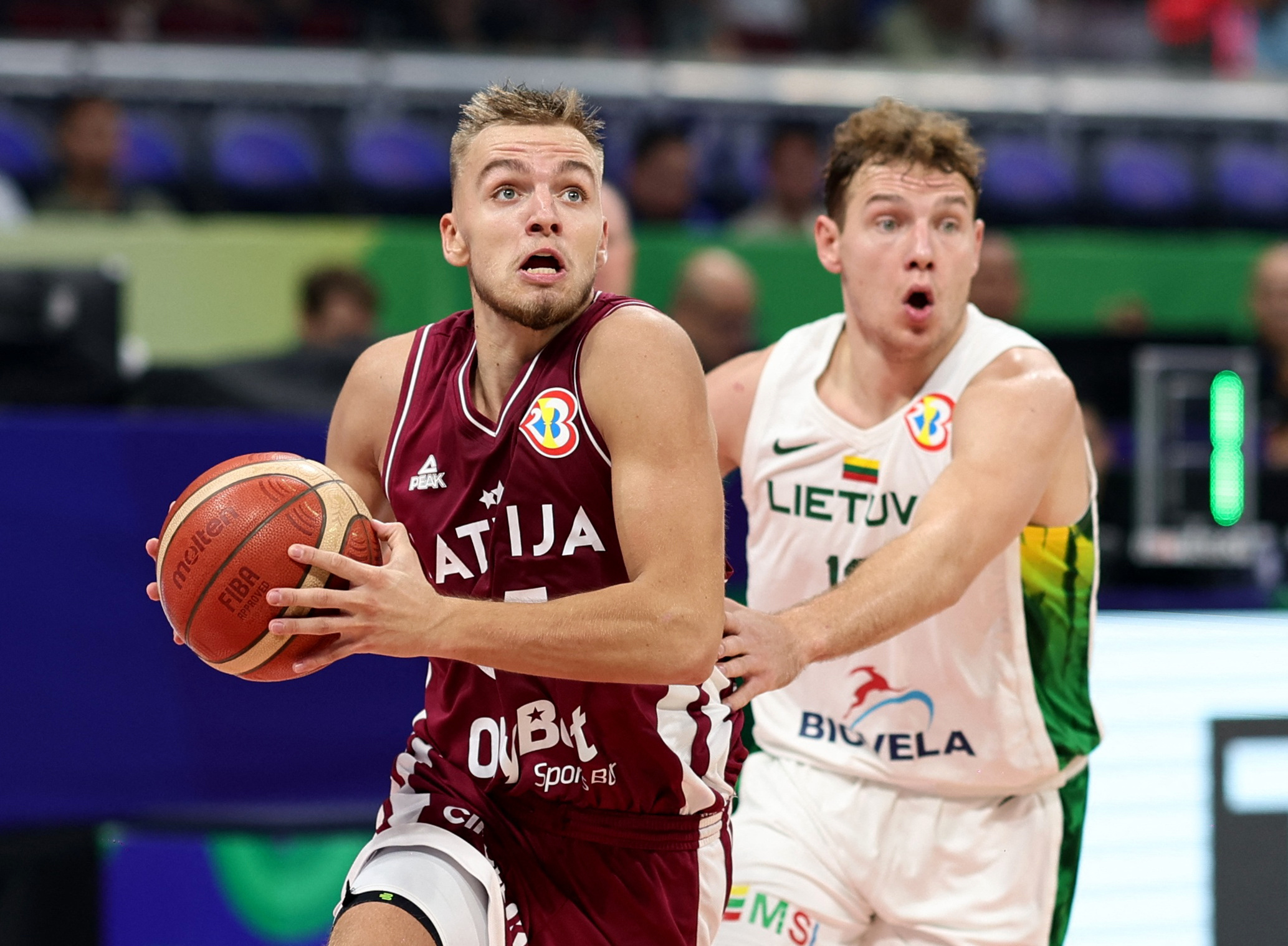 Basketball - FIBA World Cup 2023 - Classification Games 5-6 - Latvia v Lithuania - Mall of Asia Arena, Manila, Philippines - September 9, 2023 Latvia's Arturs Zagars in action with Lithuania's Rokas Jokubaitis REUTERS