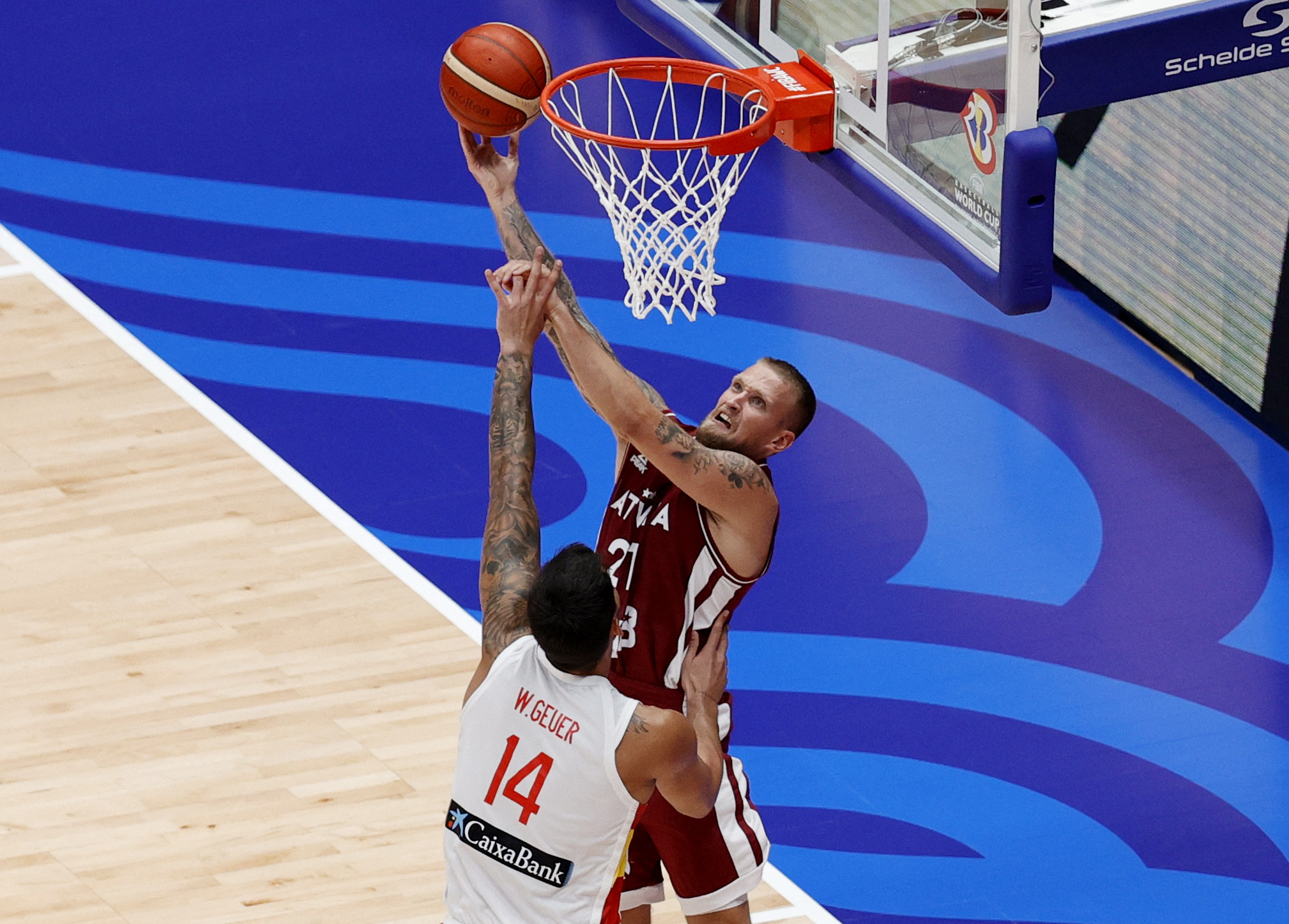 Basketball - FIBA World Cup 2023 - Second Round - Group L - Spain v Latvia - Indonesia Arena, Jakarta, Indonesia - September 1, 2023 Latvia's Aigars Skele in action with Spain's Willy Hernangomez REUTERS