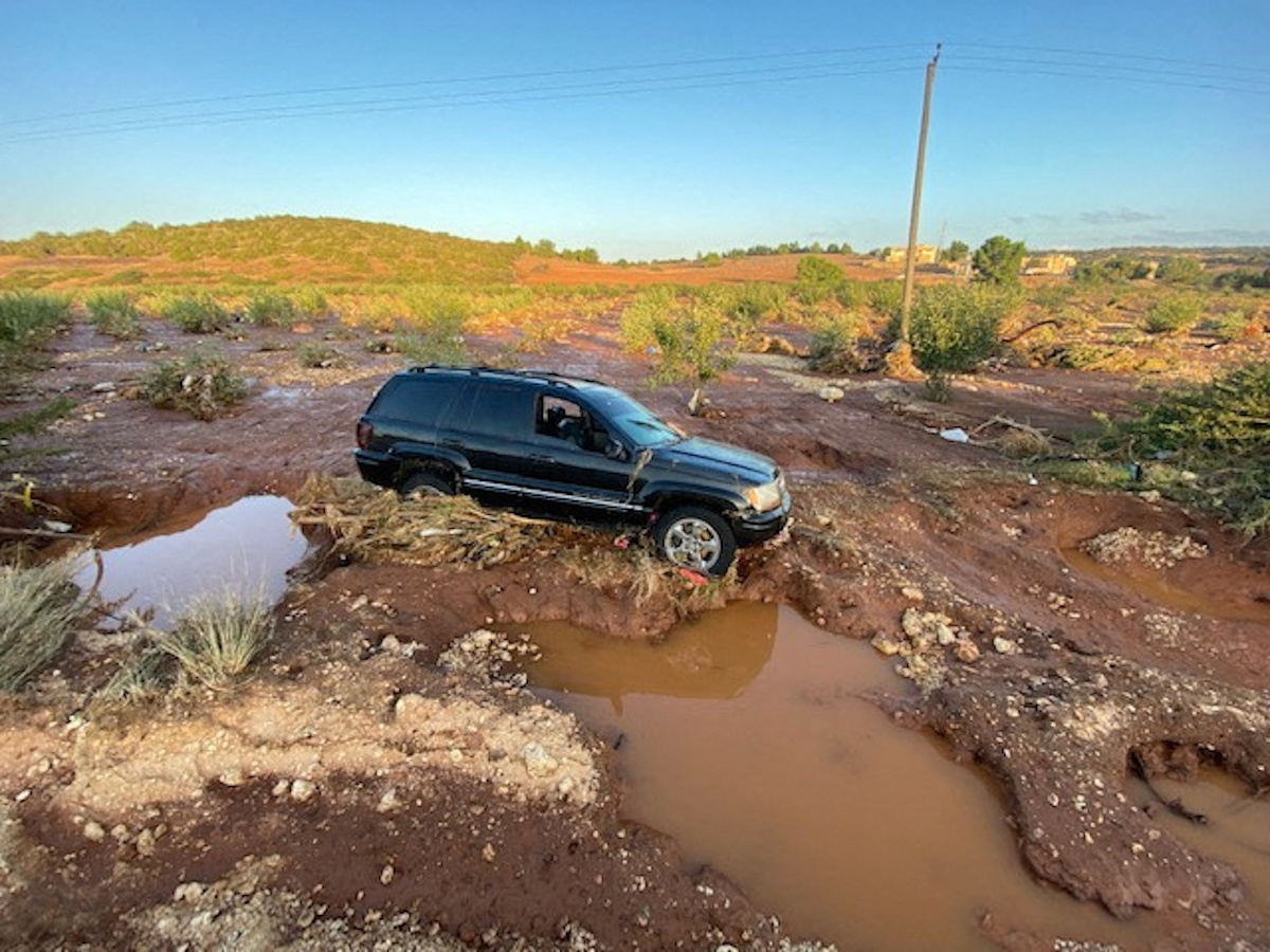 A view shows a car stuck on a damaged road, after a powerful storm and heavy rainfall hit Qandula, Libya, September 12, 2023. REUTERS