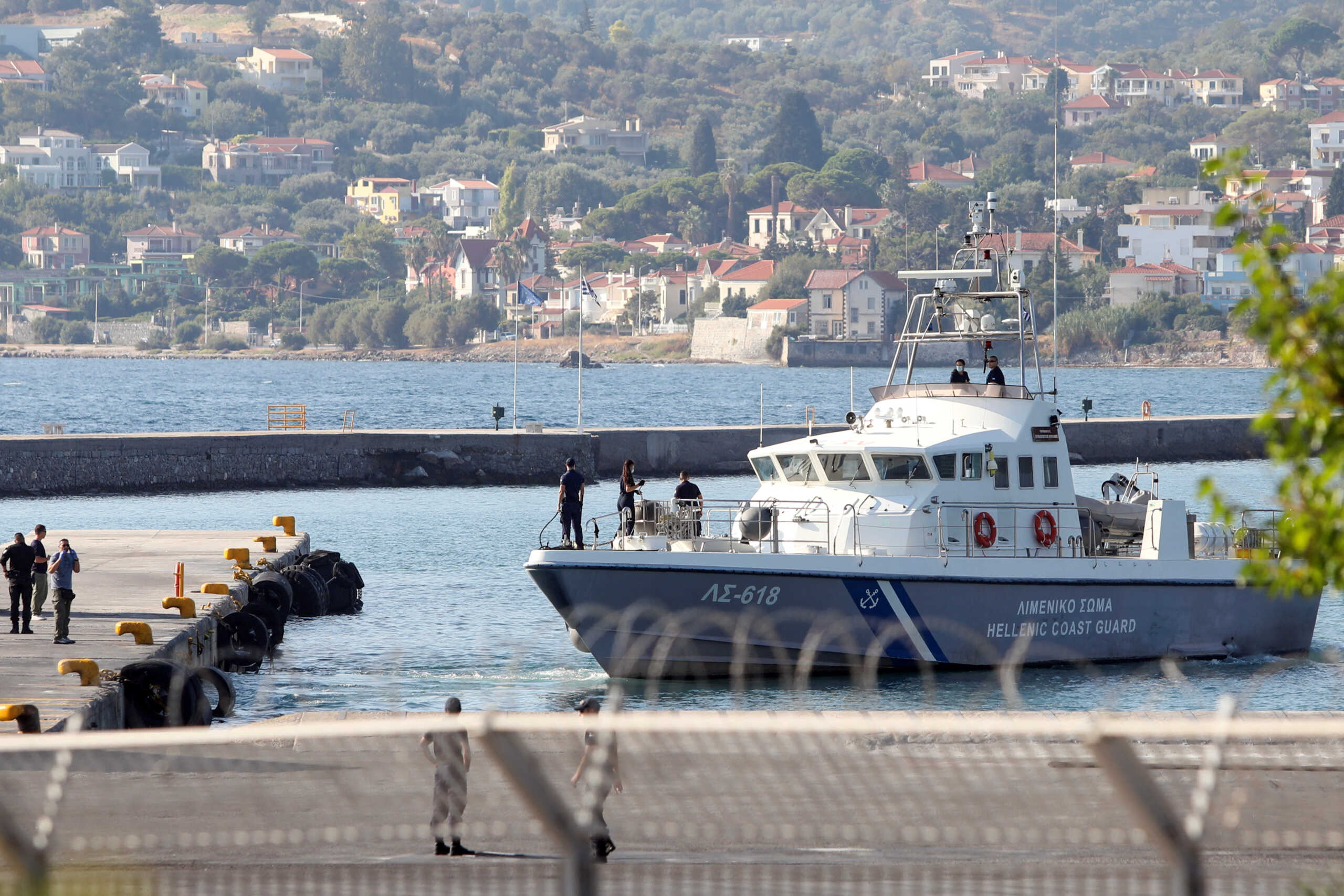 A Hellenic Coast Guard vessel with rescued migrants onboard, prepares to moor at the port of Mytilene, following a shipwreck in which four migrants drowned, off the island of Lesbos, Greece, August 28, 2023. REUTERS
