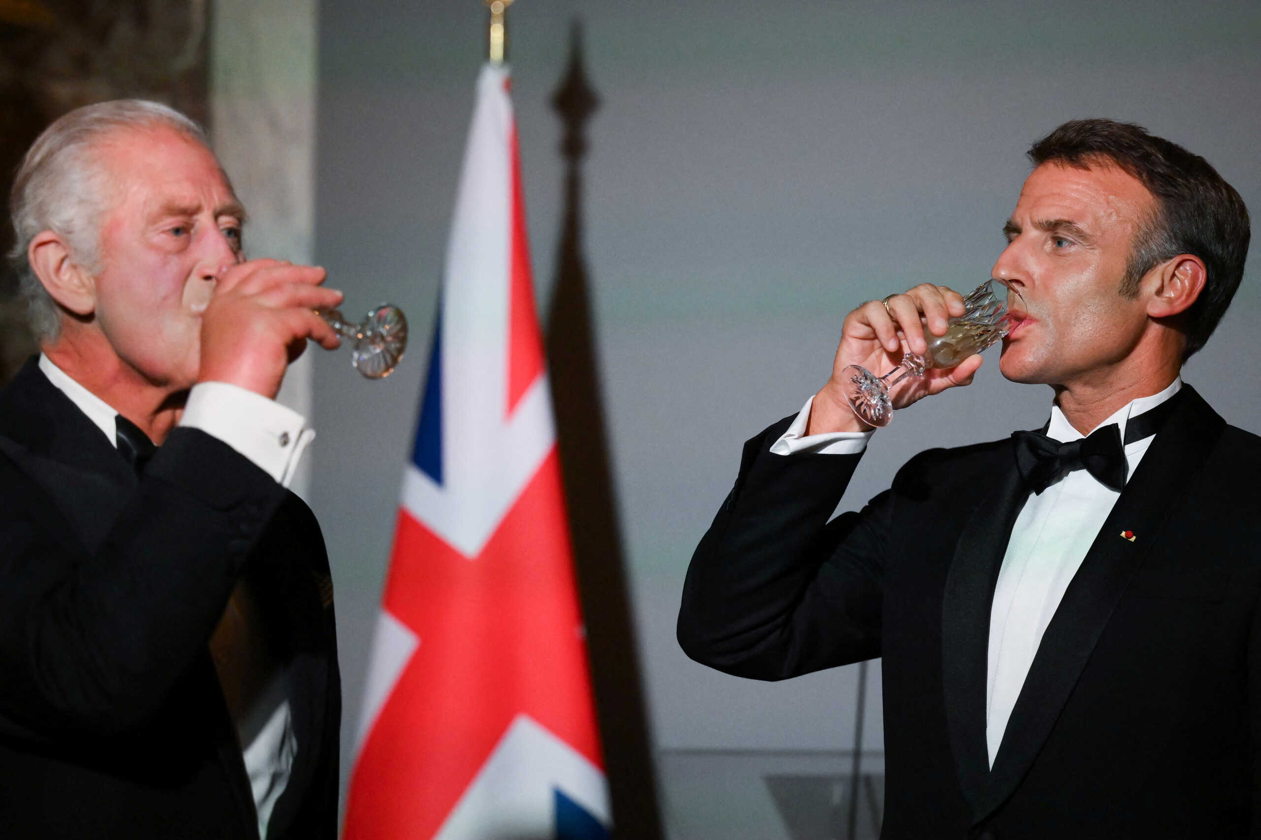 Britain's King Charles and French President Emmanuel Macron drink after a toast during a state banquet at the Palace of Versailles, west of Paris, on September 20, 2023, on the first day of a British royal state visit to France. Britain's King Charles and his wife Queen Camilla are on a three-day state visit to France. DANIEL LEAL