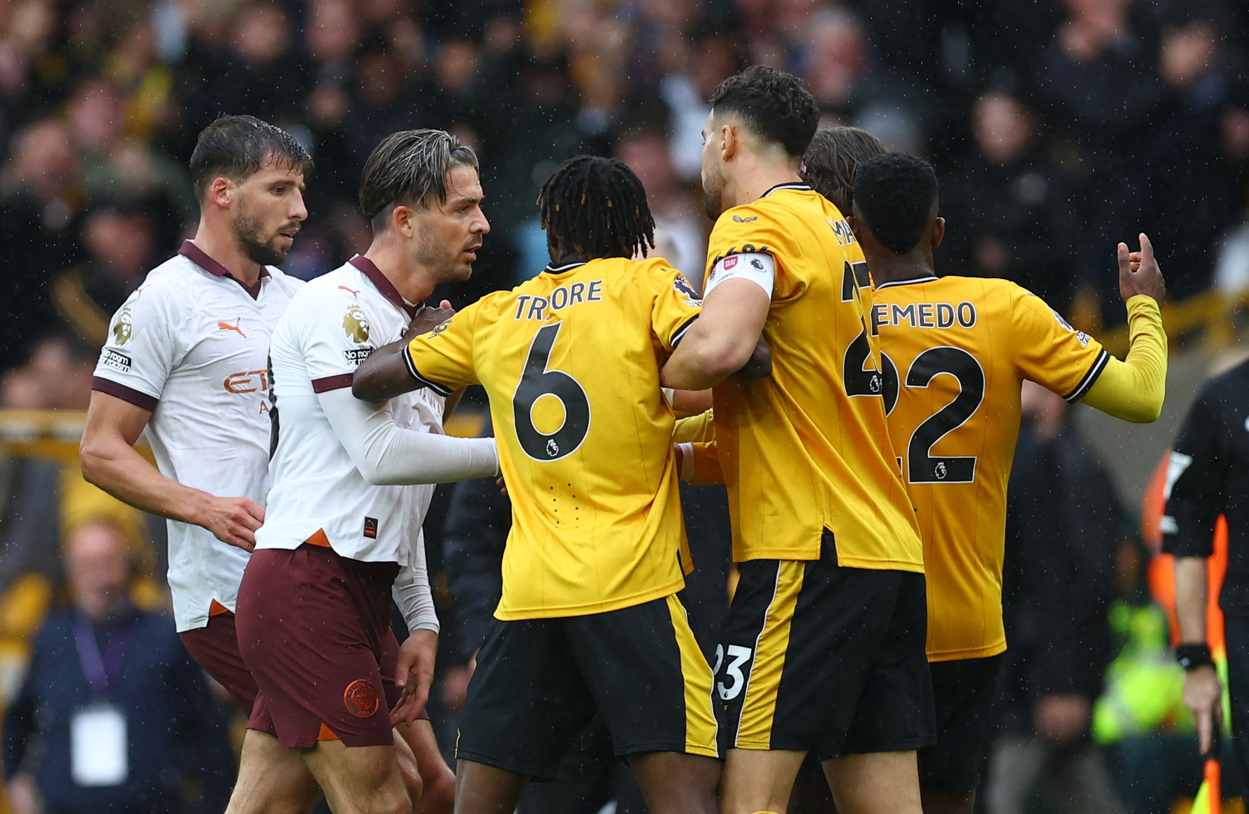 Soccer Football - Premier League - Wolverhampton Wanderers v Manchester City - Molineux Stadium, Wolverhampton, Britain - September 30, 2023 Manchester City's Jack Grealish clashes with Wolverhampton Wanderers players REUTERS