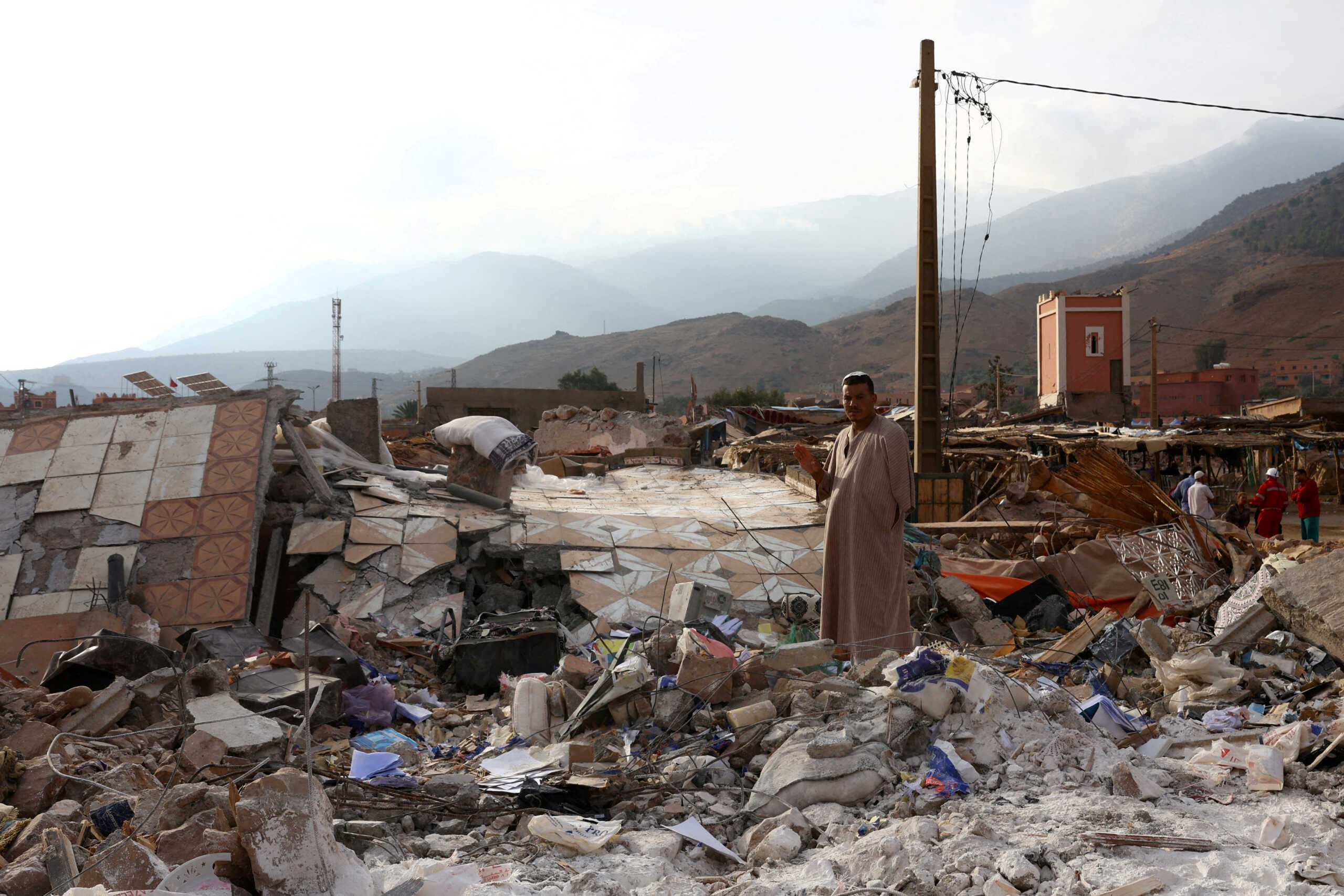 A man stands amid rubble in the aftermath of a deadly earthquake in Talat N'Yaaqoub, in Morocco September 12, 2023. REUTERS
