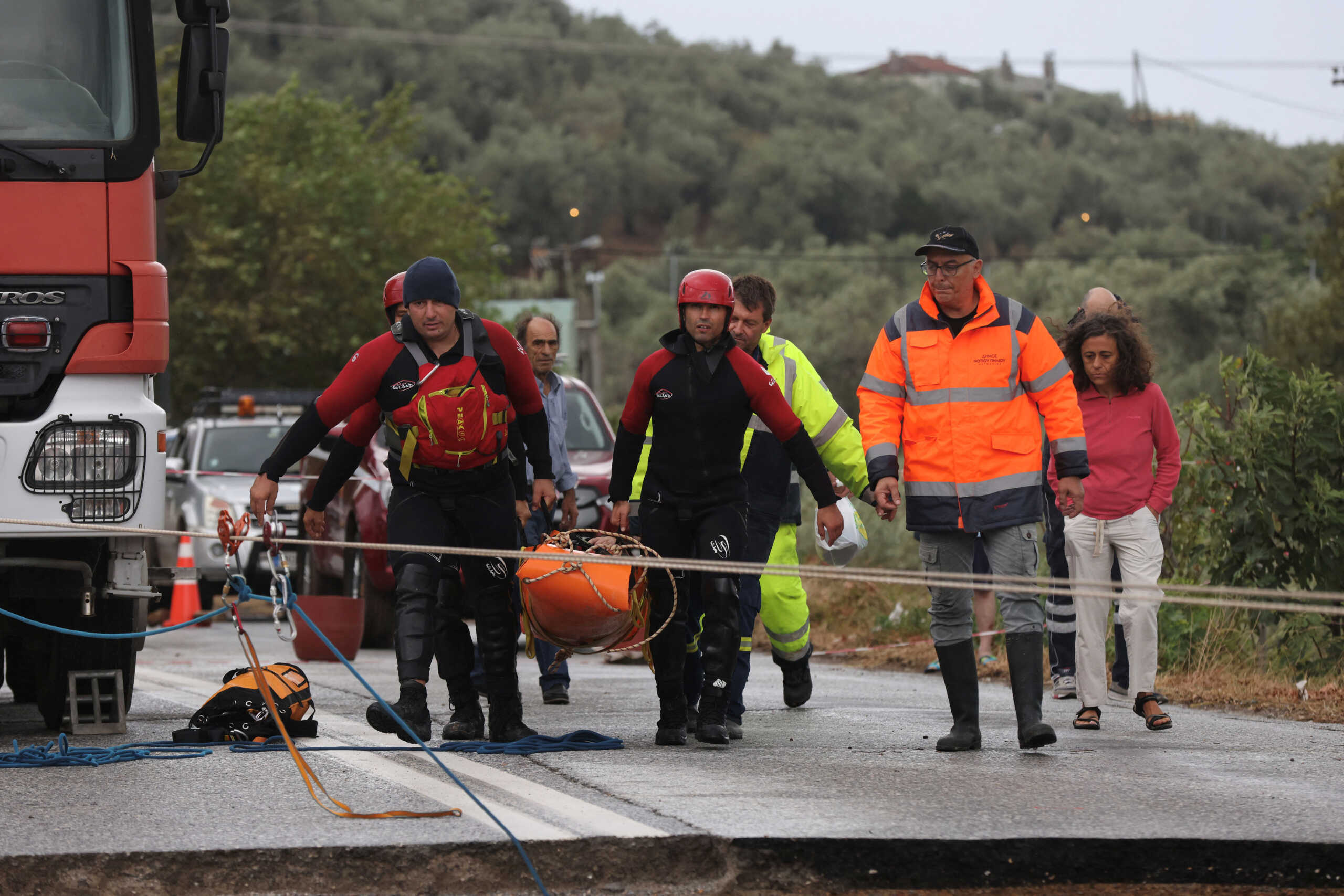 Rescuers transfer a chronic kidney disease patient over a collapsed bridge in a flooded area, as storm Daniel hits central Greece, in the village of Kala Nera, near Volos, Greece, September 6, 2023. REUTERS