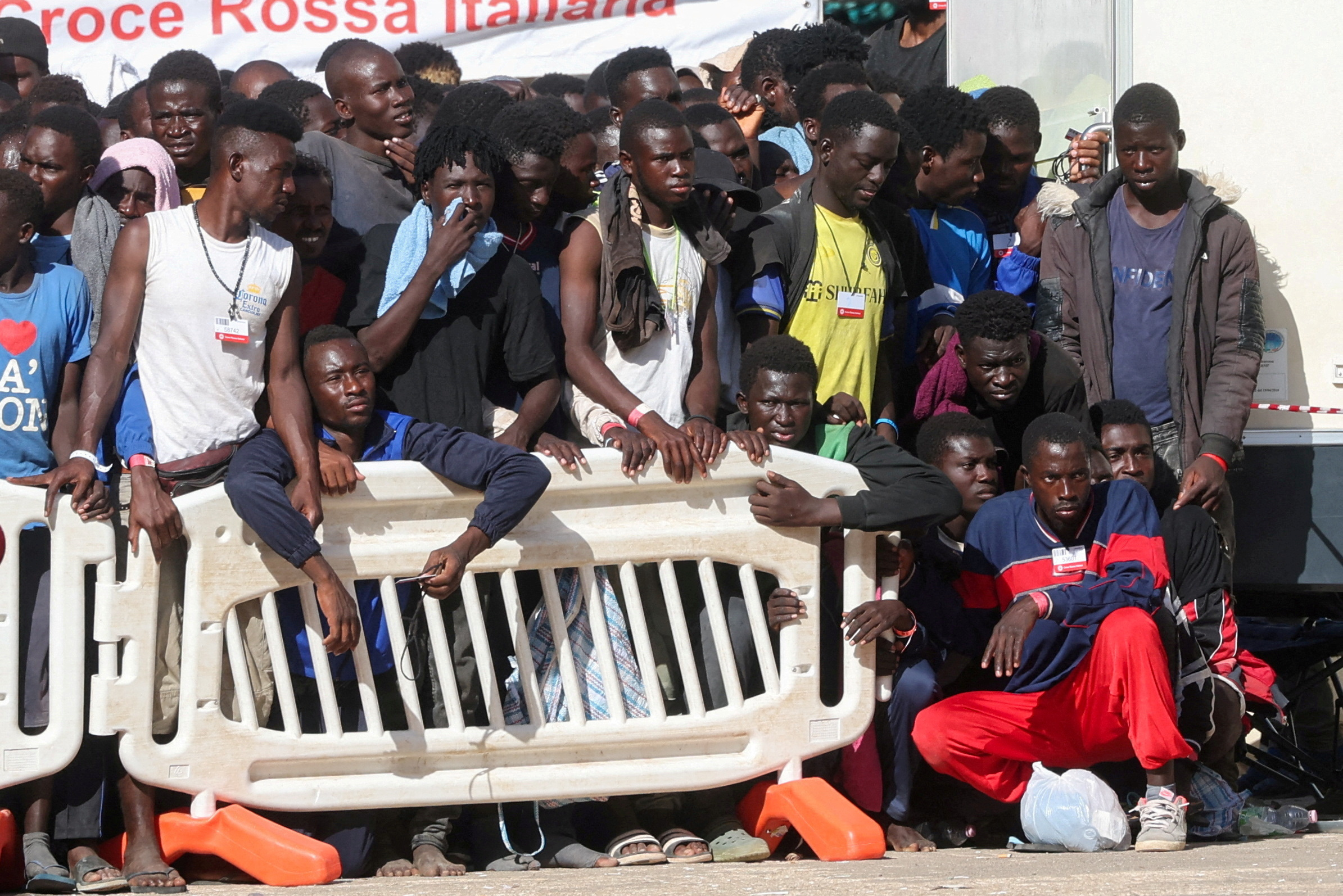 Migrants gather at the hotspot, a reception centre for migrants, ahead of European Commission President Ursula von der Leyen and Italian Prime Minister Giorgia Meloni's visit to the Sicilian island of Lampedusa, Italy, September 17, 2023. REUTERS