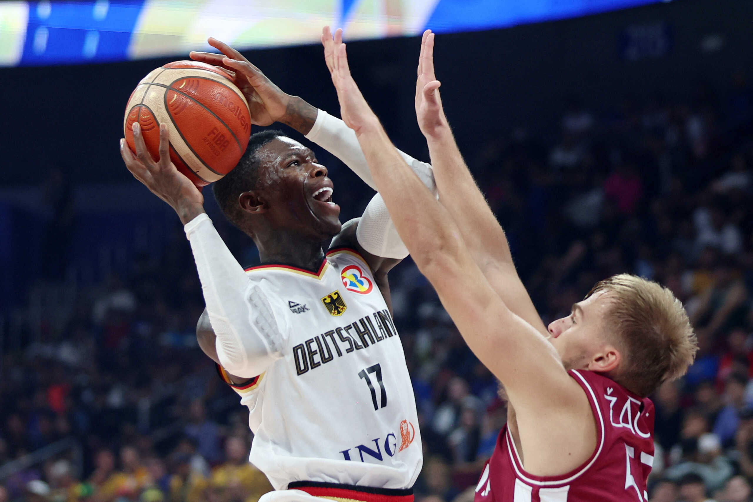 Basketball - FIBA World Cup 2023 - Quarter-Final - Germany v Latvia - Mall of Asia Arena, Manila, Philippines - September 6, 2023 Germany's Dennis Schroder in action with Latvia's Arturs Zagars REUTERS