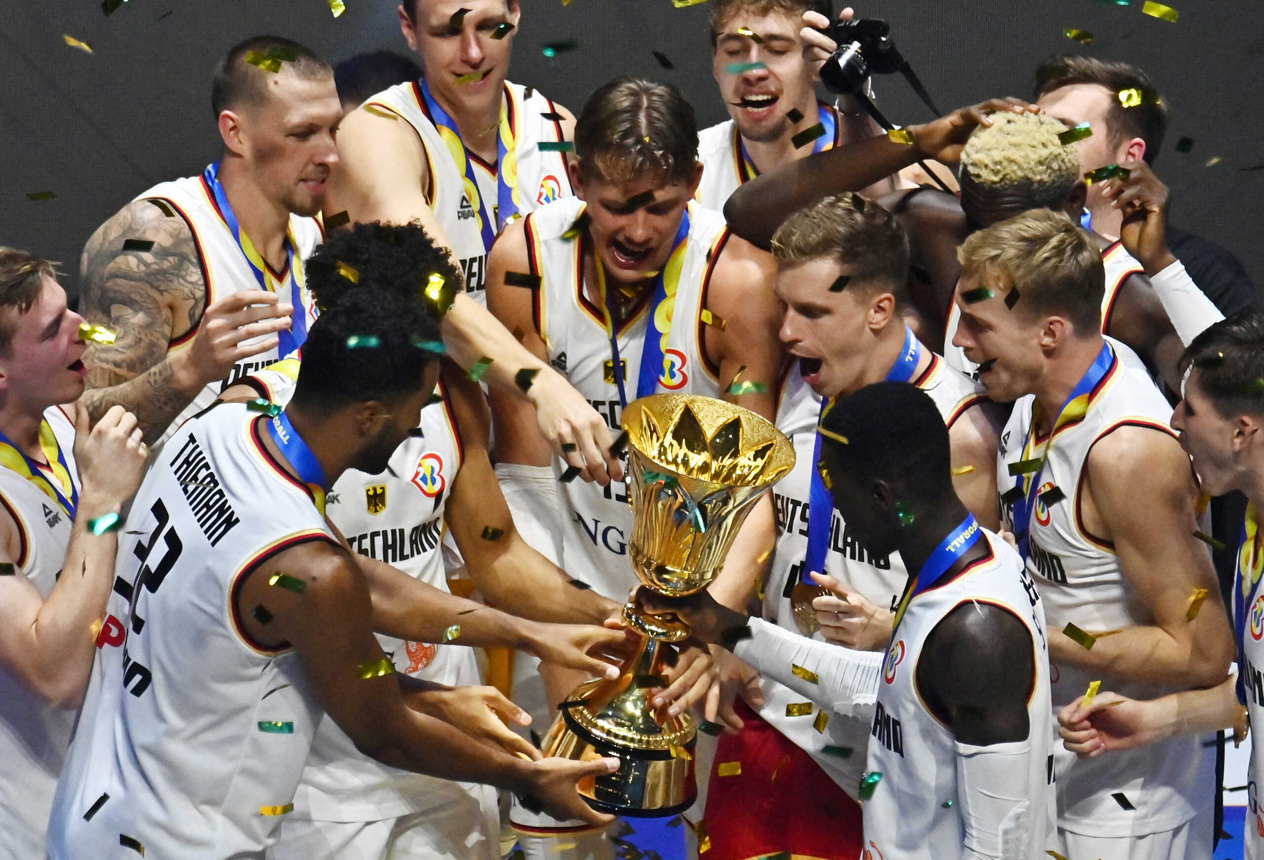 Basketball - FIBA World Cup 2023 - Final - Germany v Serbia - Mall of Asia Arena, Manila, Philippines - September 10, 2023 Germany players celebrate with the trophy after winning the FIBA World Cup 2023 Final REUTERS