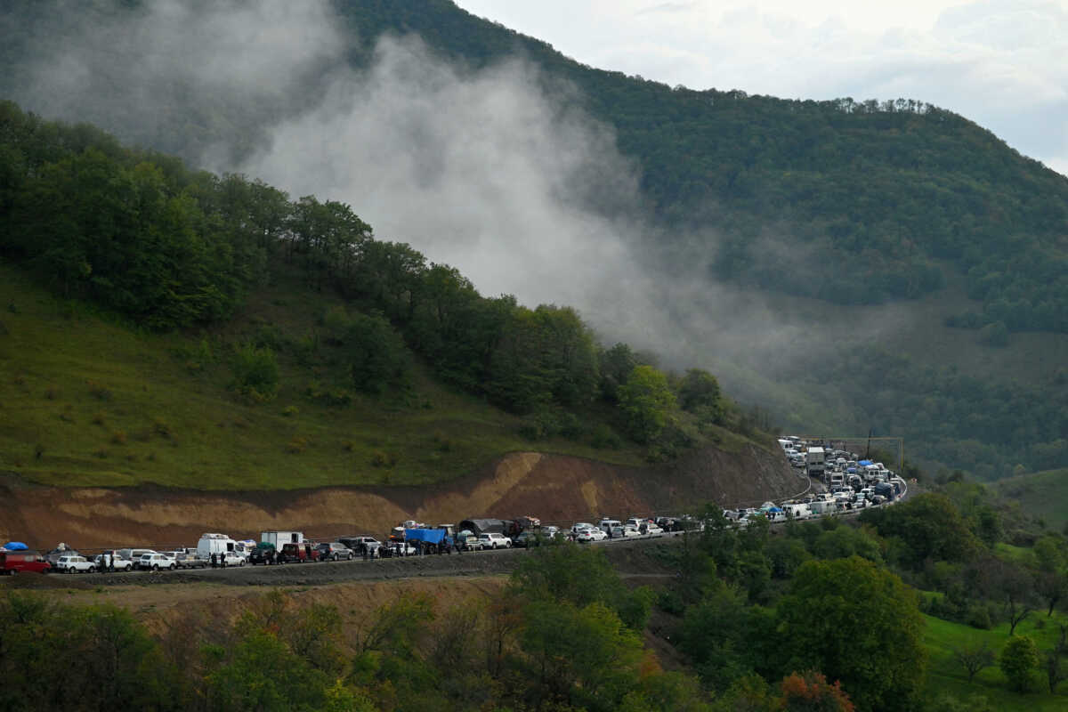 FILE PHOTO: Vehicles carrying refugees from Nagorno-Karabakh, a region inhabited by ethnic Armenians, queue on the road leading towards the Armenian border, in Nagorno-Karabakh, September 25, 2023. REUTERS