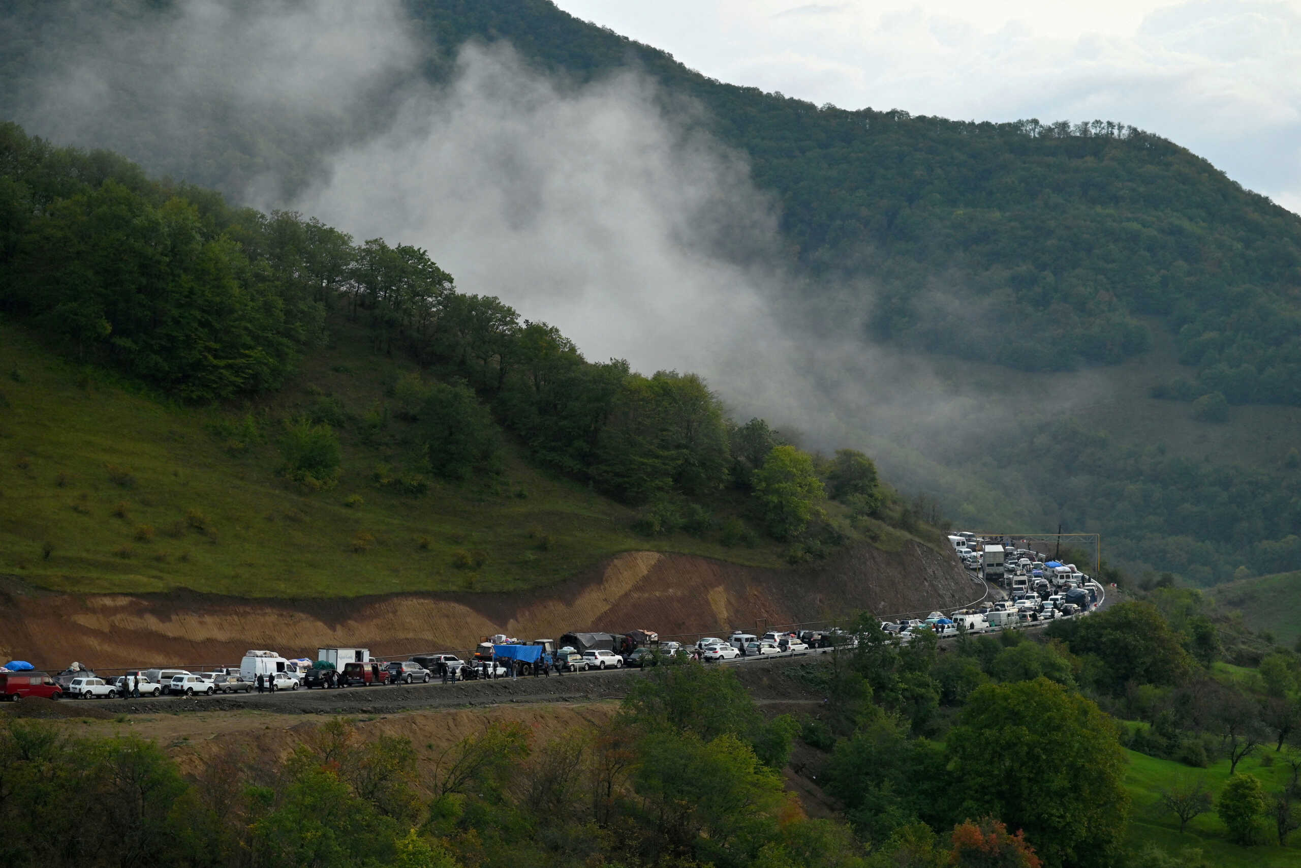 FILE PHOTO: Vehicles carrying refugees from Nagorno-Karabakh, a region inhabited by ethnic Armenians, queue on the road leading towards the Armenian border, in Nagorno-Karabakh, September 25, 2023. REUTERS