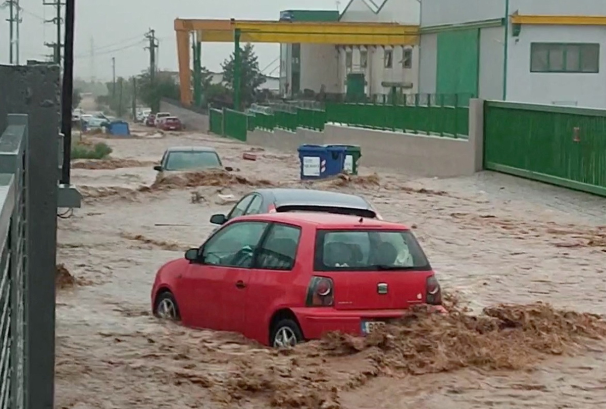 Partially submerged cars are seen in a flooded road as torrential rain hits Volos, Greece, September 5, 2023 in this still image from video obtained from social media. Instagram