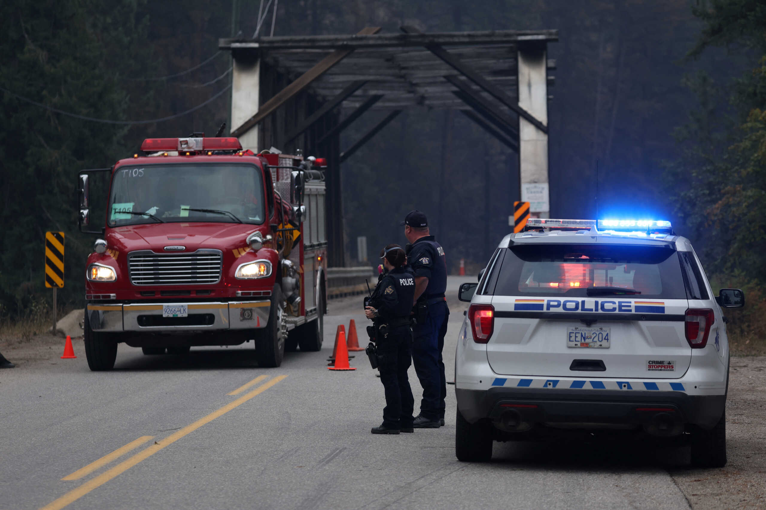 Royal Canadian Mounted Police control a roadblock preventing locals from returning home after the Bush Creek wildfire destroyed dozens of homes and other buildings in Scotch Creek, Lee Creek and Celista in the North Shuswap Lake region of British Columbia, Canada. August 23, 2023 REUTERS