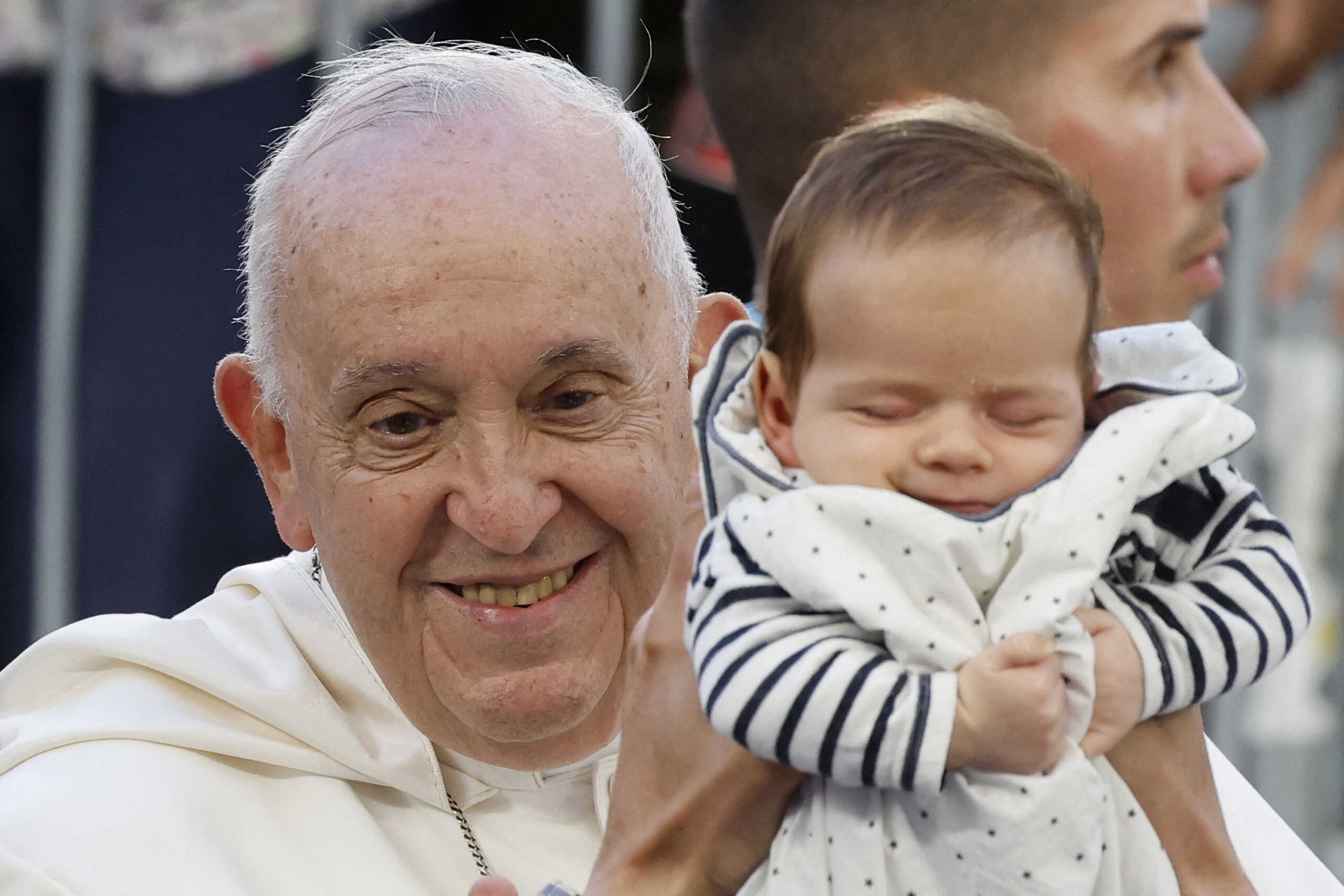 A baby is held up to Pope Francis, as he arrives at the Velodrome stadium, in his popemobile for a mass in Marseille, France, 23 September 2023. Sebastien Nogier
