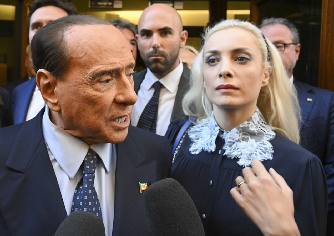 epa10250906 Leader of 'Forza Italia' Silvio Berlusconi speaks to journalists leaving the parliamentary groups at the Chamber of Deputies with Member of Italian Chamber of Deputies, Marta Fascina (R), Rome, Italy, 18 October 2022.  EPA