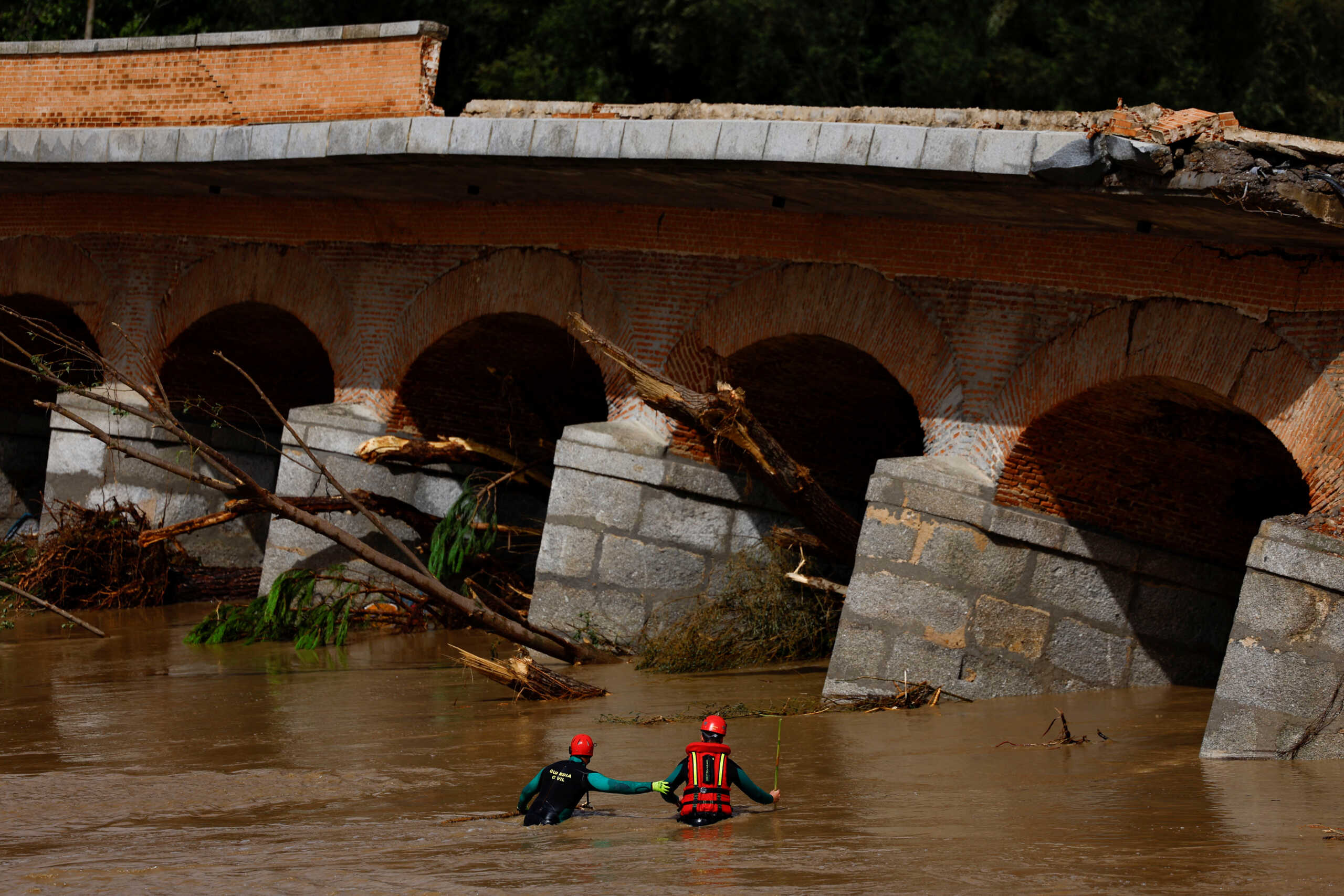 Members of the Spanish Civil Guard search and rescue team look for a missing person by a bridge that partially collapsed, following heavy rain in Aldea del Fresno, Spain September 4, 2023. REUTERS