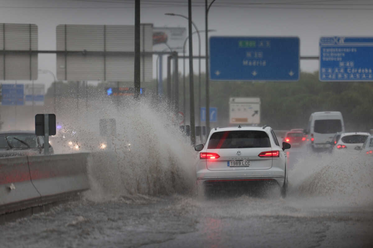A vehicle passes through a large puddle of water caused by heavy rain following a Spain's State Meteorological Agency (AEMET) red alert for severe storms, Madrid, Spain, September 3, 2023. REUTERS