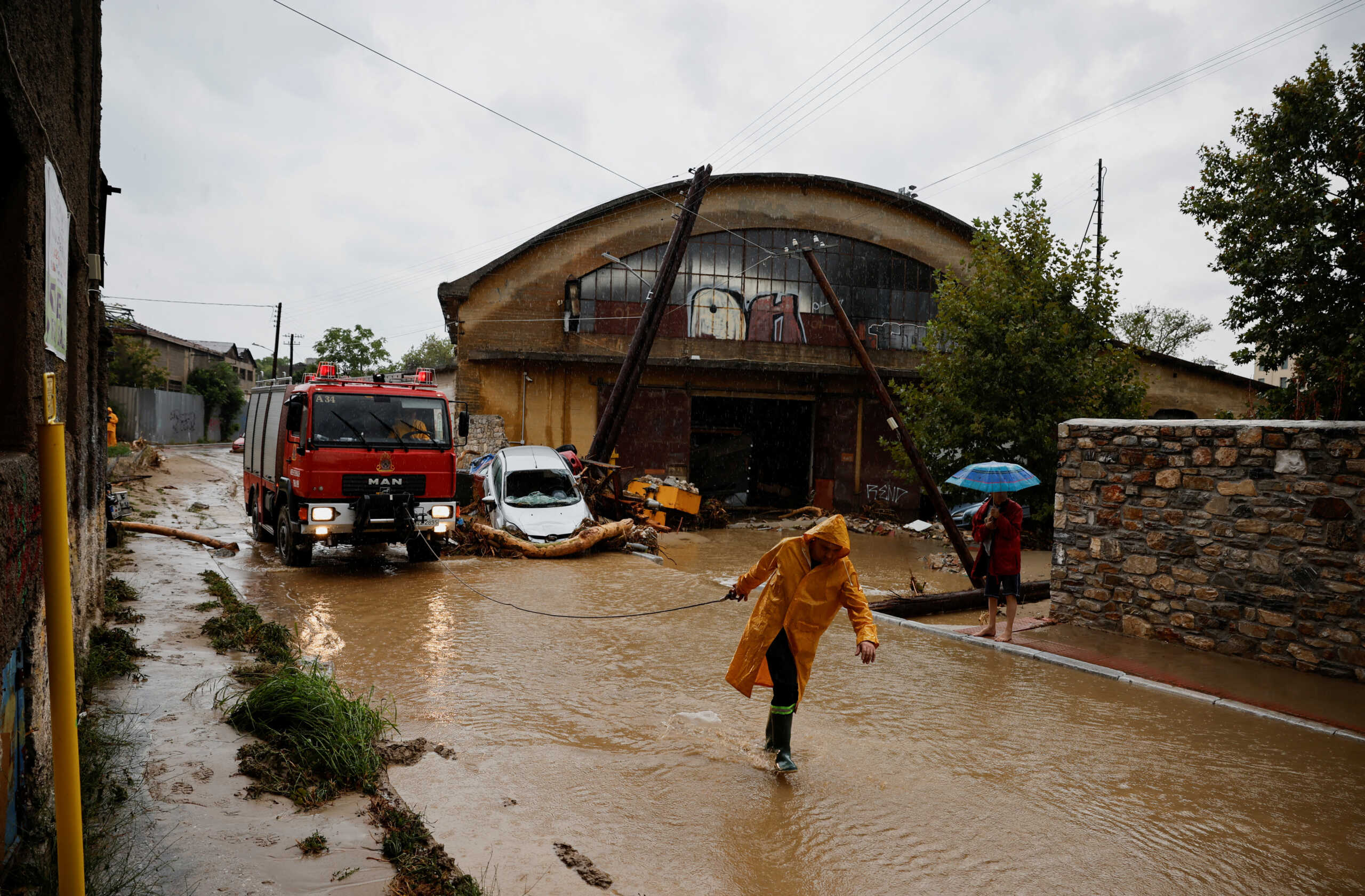 A fireman works on a flooded road due to the impact of storm "Daniel", in the city of Volos, Greece, September 6, 2023. REUTERS