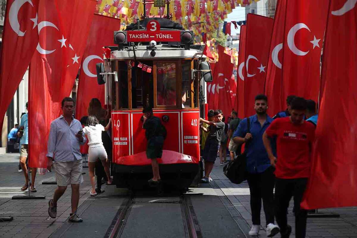 People stroll at the main shopping and pedestrian street of Istiklal which is decorated with Turkish flags to mark the Victory Day, in Istanbul, Turkey August 30, 2023. REUTERS