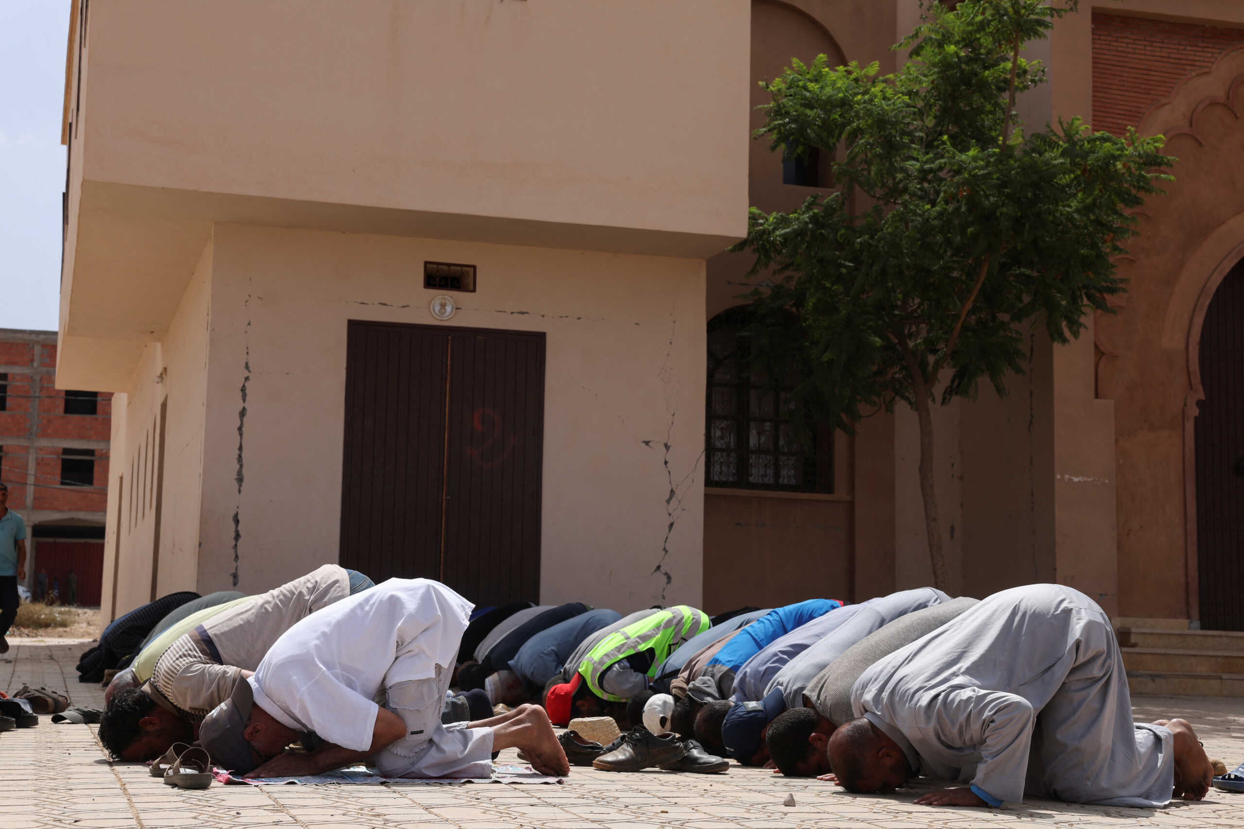 Moroccan Muslims attend the Friday prayers outside the mosque in the aftermath of a deadly earthquake, in Amizmiz, Morocco September 15, 2023. REUTERS