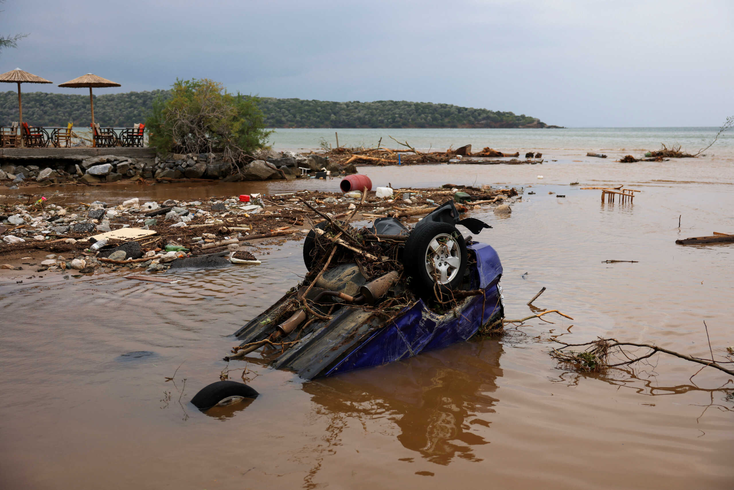 A destroyed car is partially submerged on the seaside, as storm Daniel hits central Greece, in the village of Milina, Greece, September 6, 2023. REUTERS
