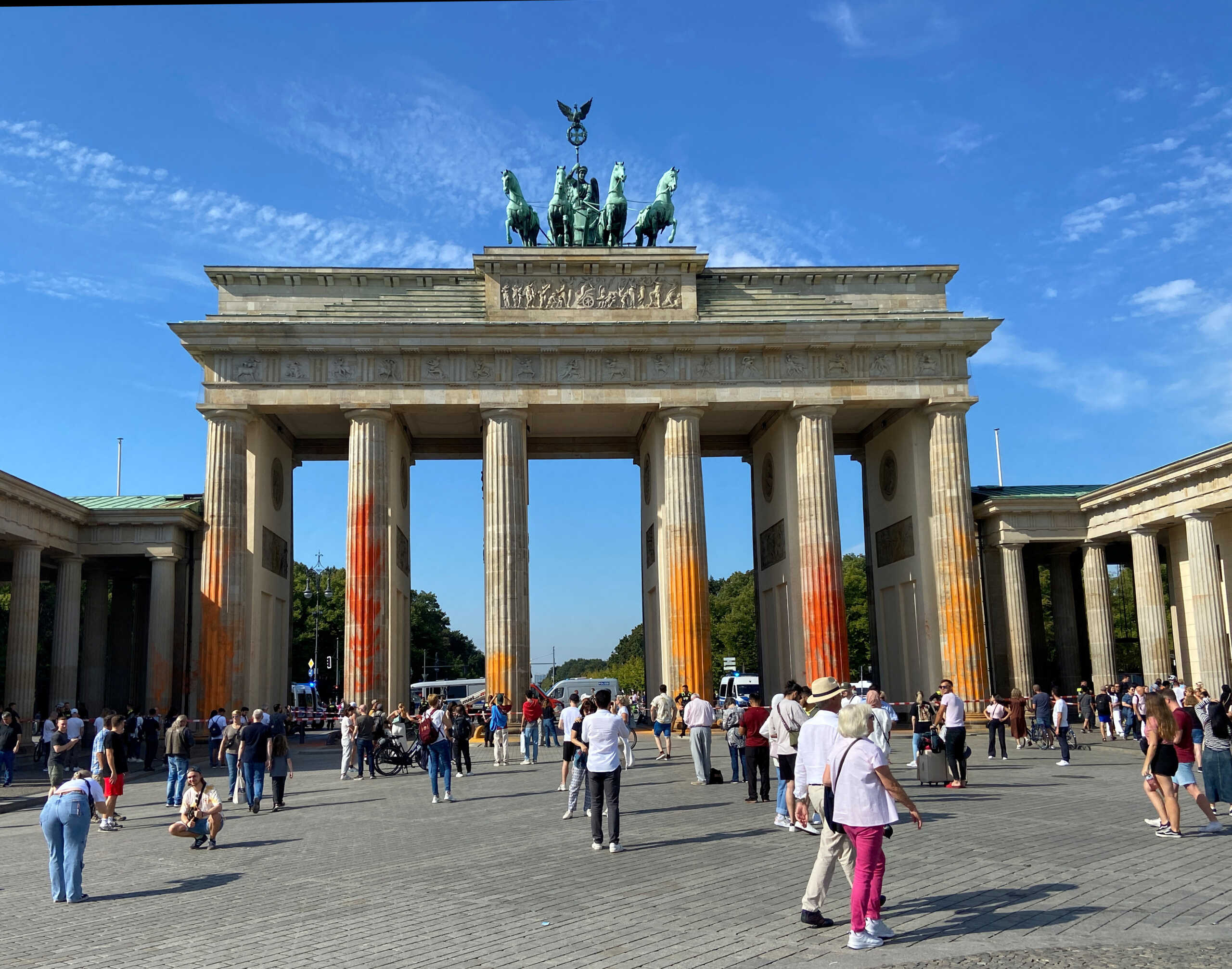 People walk in front of the Brandenburg Gate after Last Generation ("Letzte Generation") climate activists threw paint on the columns of the Brandenburg Gate in Berlin, Germany, September 17, 2023.     REUTERS